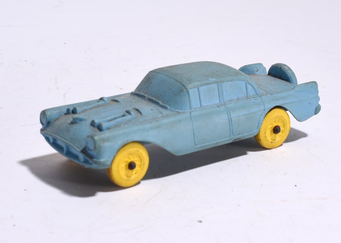 Plastic Toy Sedan Automobile: Molded plastic toy sedan in light blue finish with yellow wheels. Mid-century styling with molded body details and light wear from age and use.