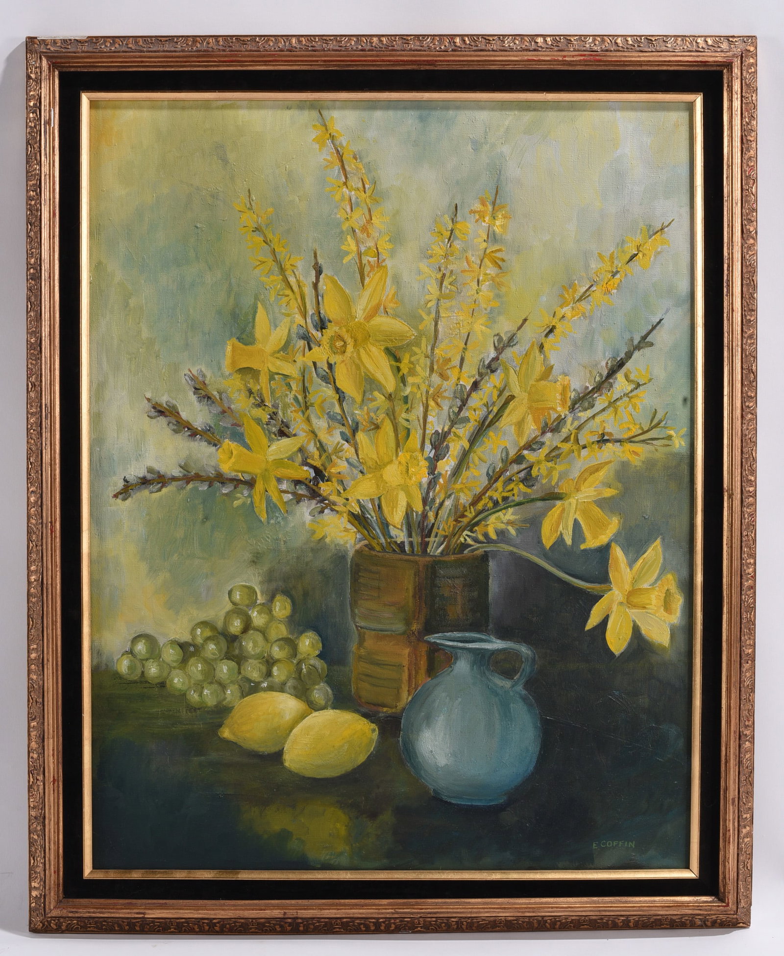 E. Coffin Floral Still Life Oil Painting Signed: 26"x33" Original oil painting by E. Coffin depicting a still life arrangement of blooming yellow daffodils with grapes, lemons, and a blue pottery jug. Signed lower right and framed.