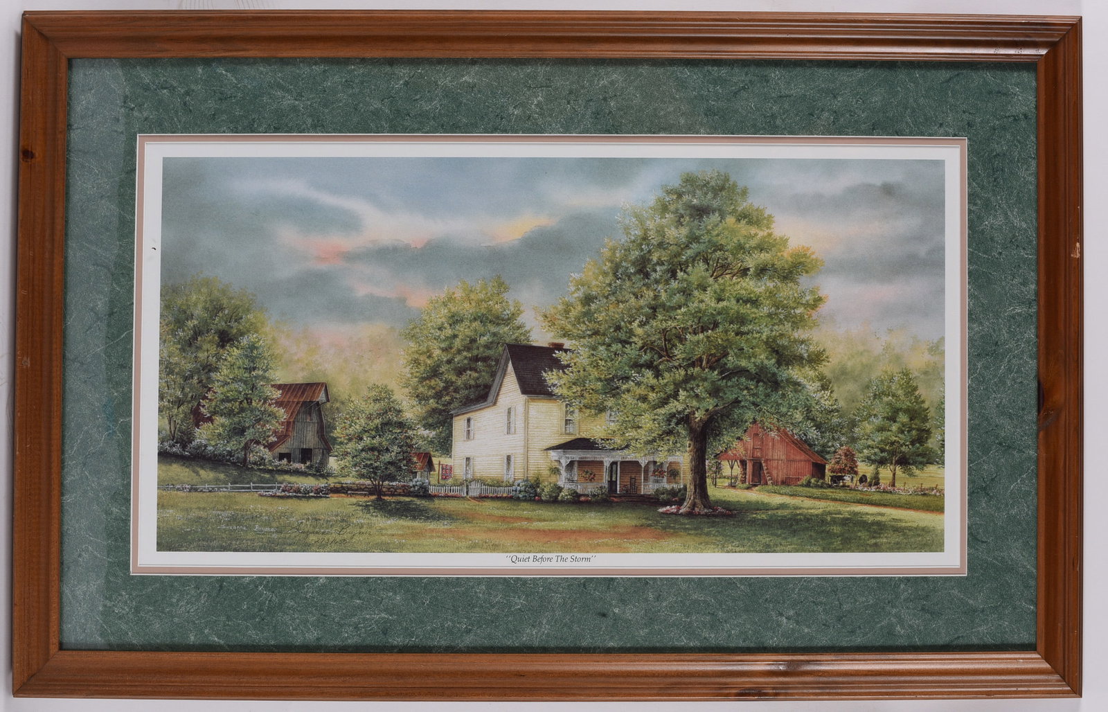 Quiet Before the Storm Framed Pencil Signed Limited Edition Landscape Print: 34"x22" Signed and numbered limited edition print titled Quiet Before the Storm, depicting a peaceful farmhouse with barns beneath dramatic gathering clouds. Professionally matted in a decorative gree