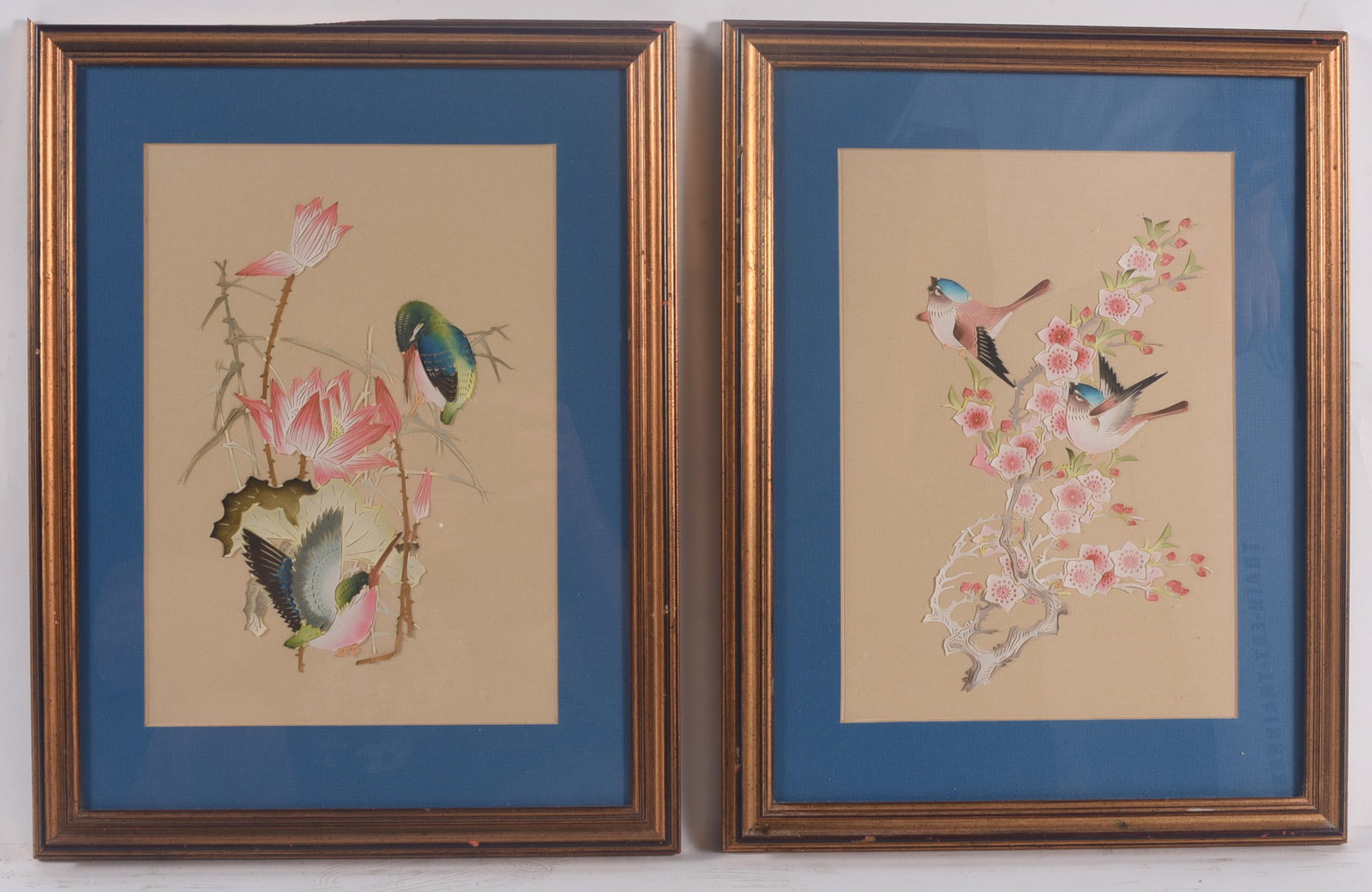 Framed Pair of Asian Bird & Floral Prints: 13"x17" each Pair of framed Asian-style decorative prints depicting colorful birds among lotus blossoms and flowering branches. Matted in blue and housed in matching gilt frames, ready for display.