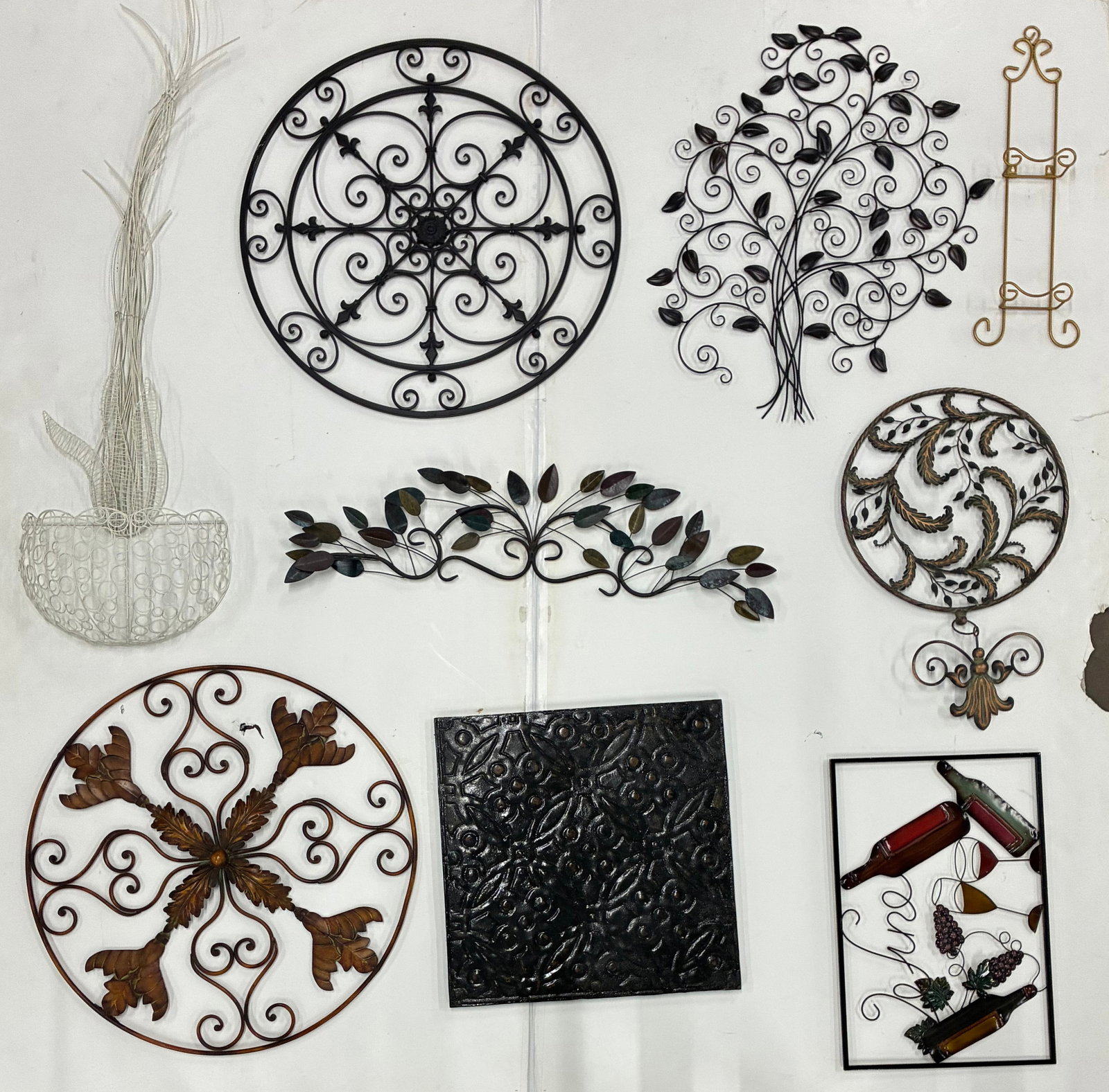 Decorative Metal Garden Wall Art Group: Average 32" Assorted decorative metal wall art including circular medallions, scrolling tree, floral designs, wall planter, embossed panel, wine-themed art, and display easel.
