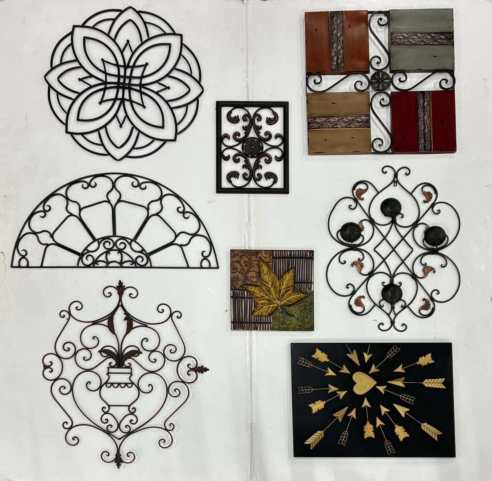 Metal Garden Wall Art & Decor Assortment: Largest 27" Assortment of decorative metal wall art including geometric designs, scrollwork panels, floral motifs, leaf plaque, wrought iron wall d?cor, and heart with arrows accent.