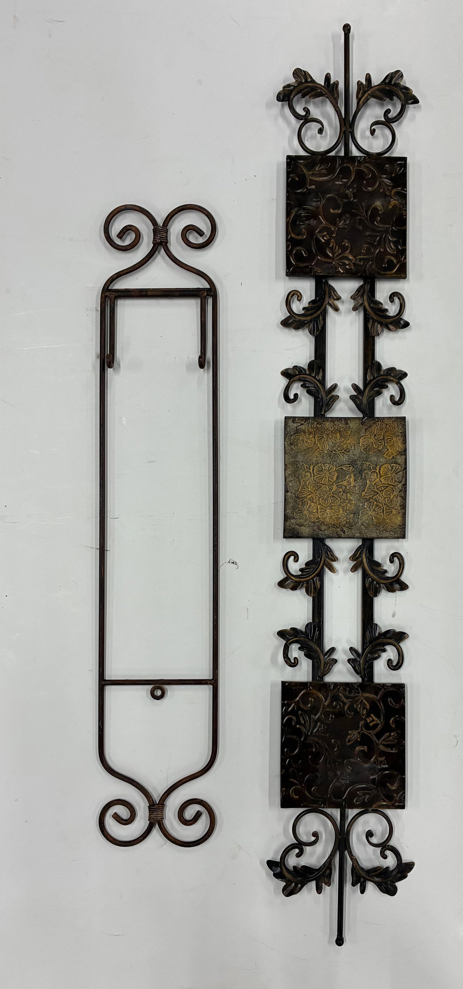 Metal Wall Decor Pair: Largest 10"x57" Pair consisting of a tall wrought metal wall rack or holder and a decorative vertical metal wall panel with embossed floral tile accents.