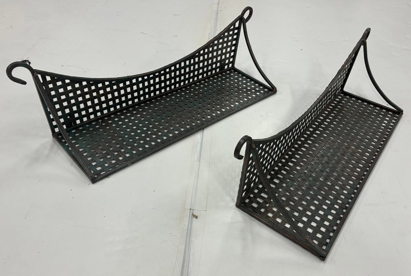Pair of Metal Shelves: 26"x8" each Pair of heavy-duty metal racks with woven lattice construction and side handles for firewood storage.