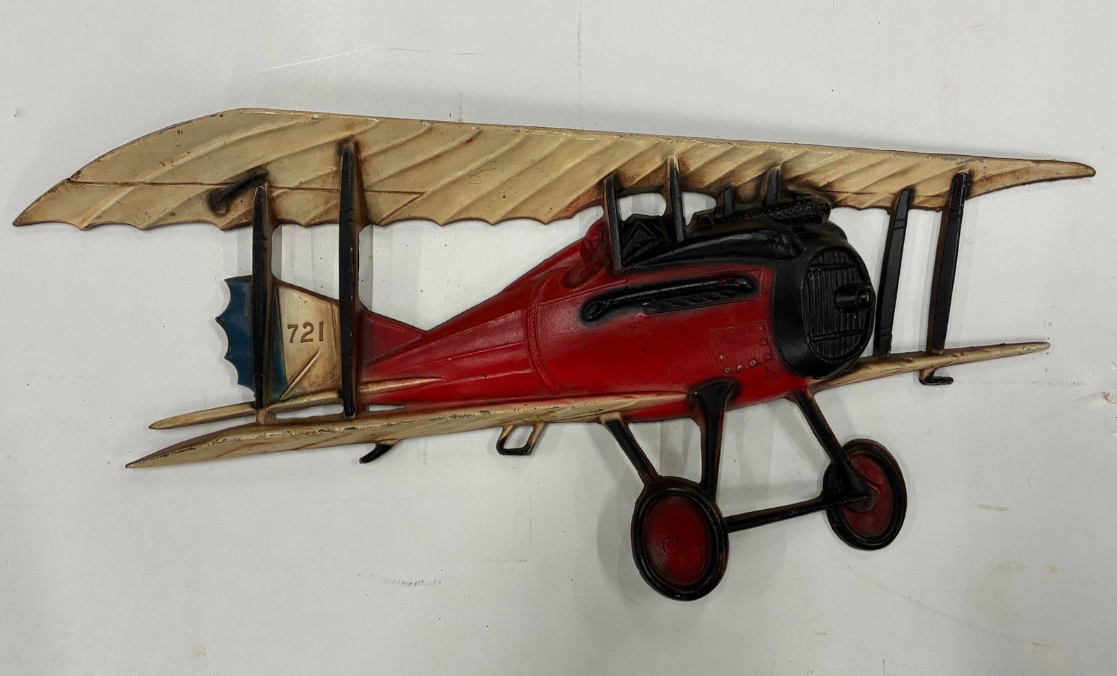 Metal Biplane Wall Sculpture: 18"x9" Decorative metal wall sculpture of a vintage biplane with hand-painted red and cream finish.