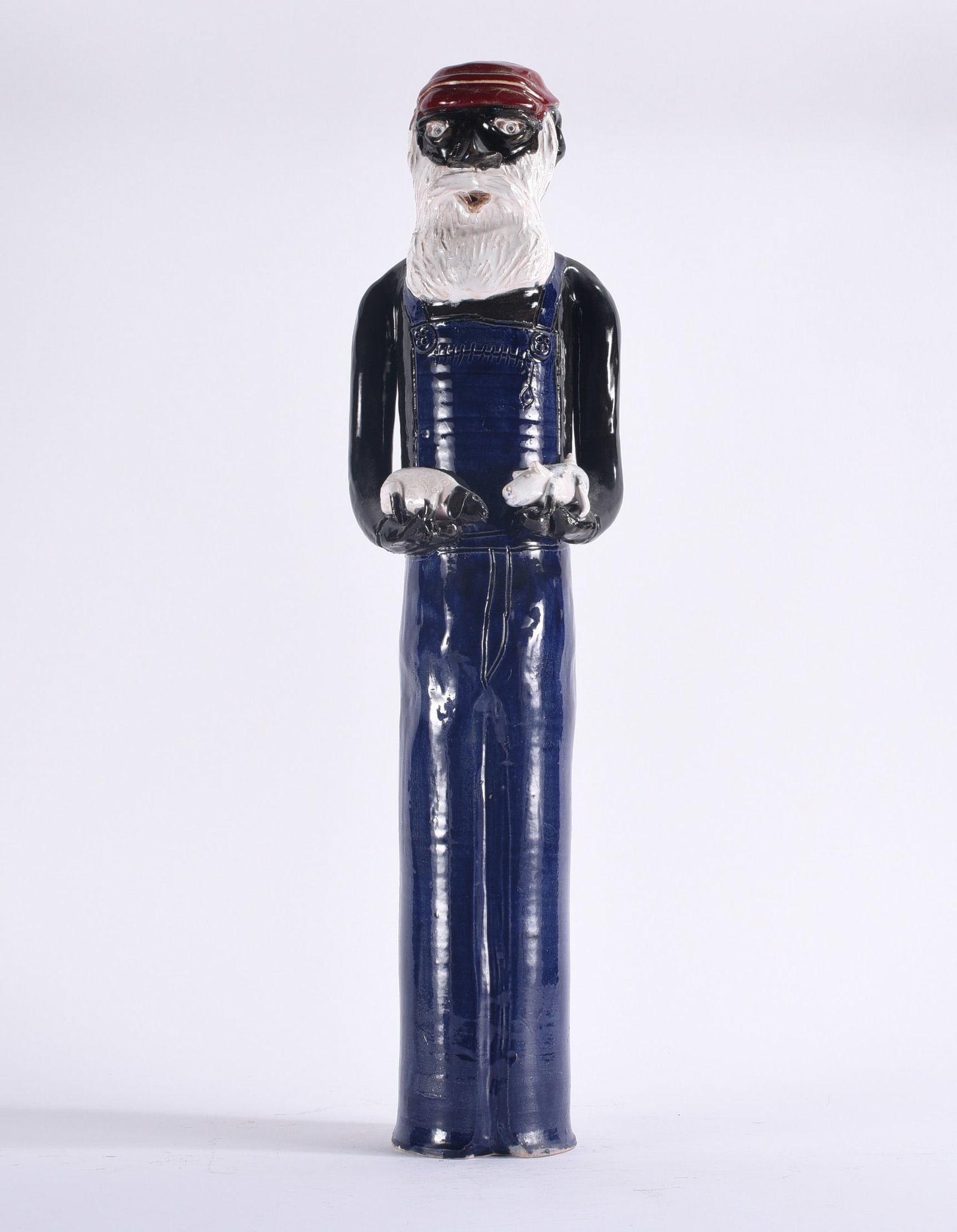 Claude Miller Large Folk Pottery Figural: 24" Tall folk pottery figural depicting a bearded man in blue overalls and red cap, holding two small modeled animals in his hands, with richly glazed and incised details.