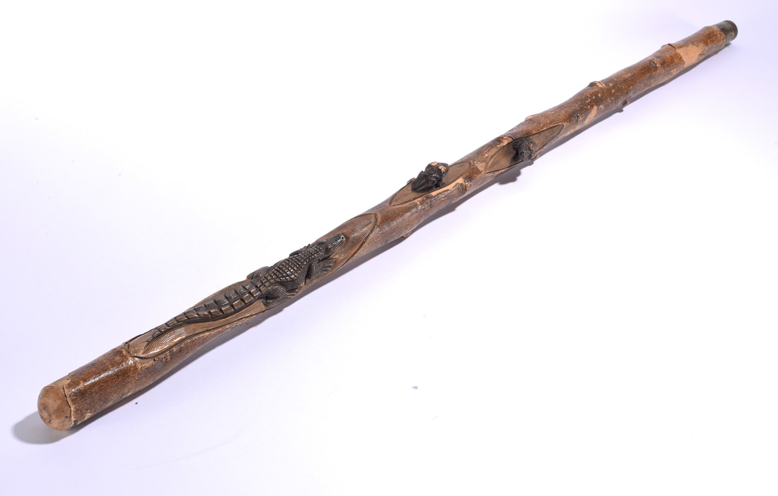 Folk Art Carved Alligator Cane ca. 1920: 35" Carved wooden folk art cane featuring a prominent relief-carved alligator along the shaft with additional animal and foliate motifs, showing a naturally aged surface.
