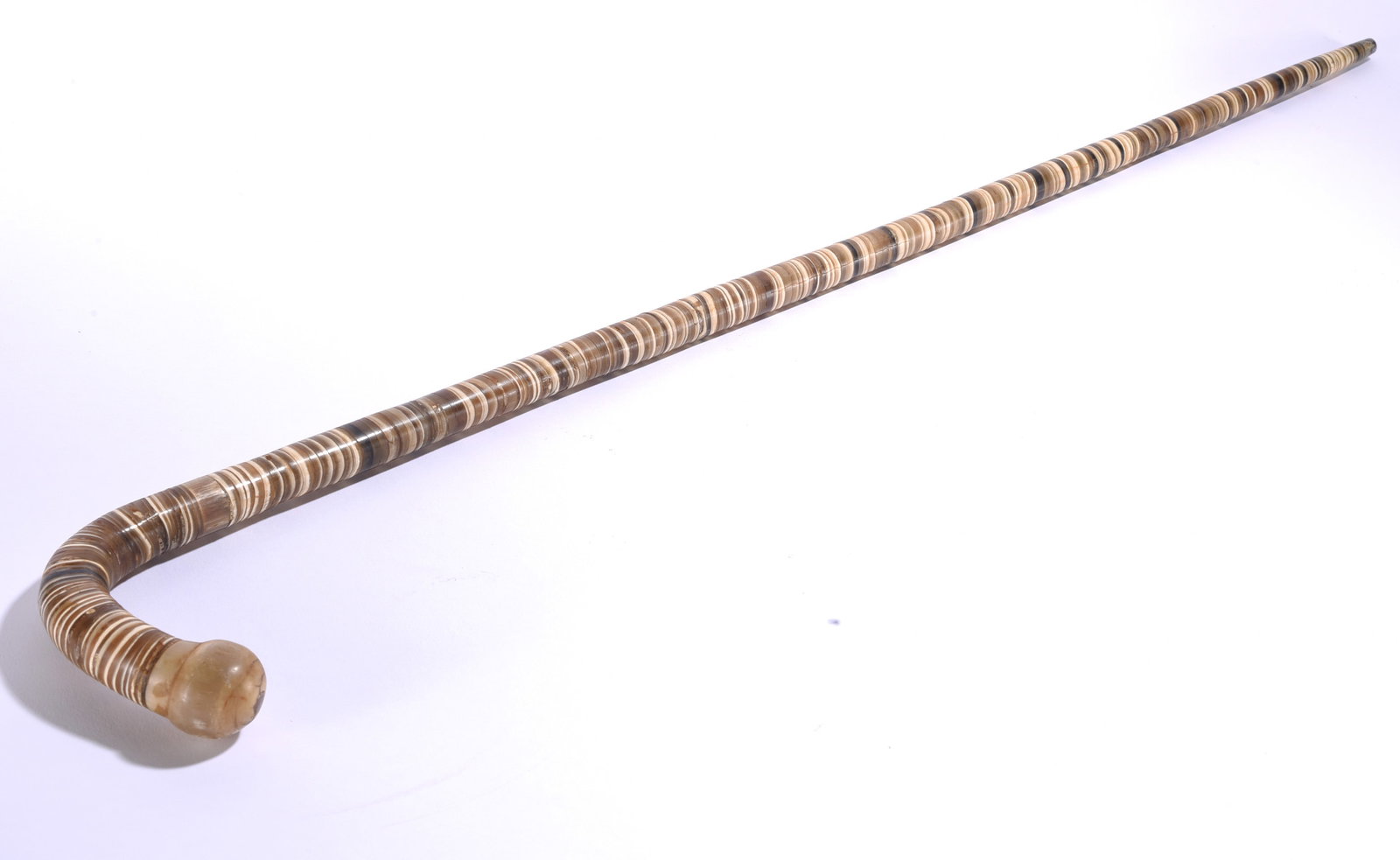 Folk Art Vertibrate Cane: 36" Unusual folk art cane constructed with a repeating stacked or vertebra-like pattern along the full shaft, terminating in a curved crook handle.