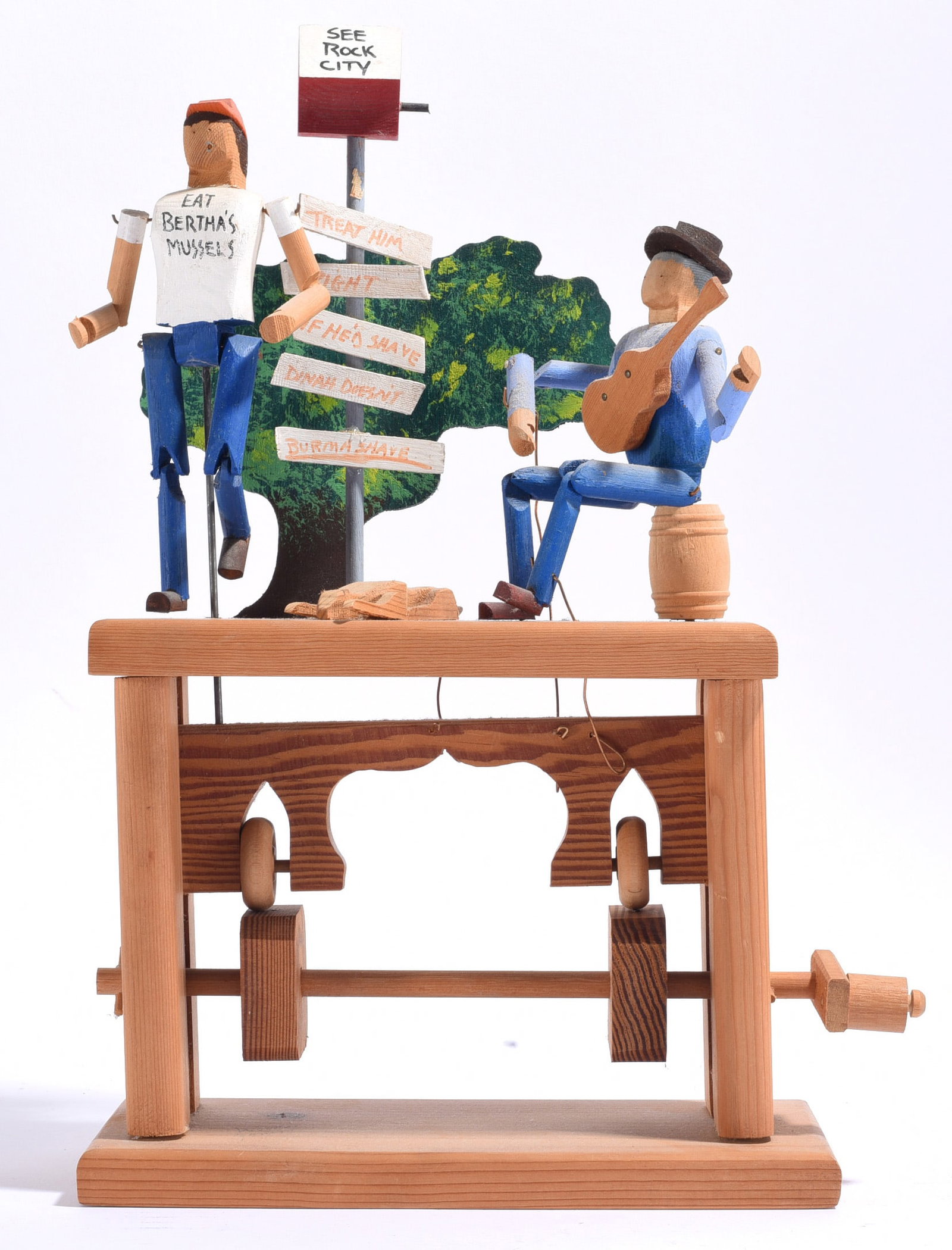 Woody Jones Folk Art Wood Mechanical Carving: 9" x17" Woody Jones folk art mechanical wood carving depicting two figures and a musician at Rock City, complete with directional signs and a hand-cranked mechanism below. Carwood "Woody" Jones of Dec