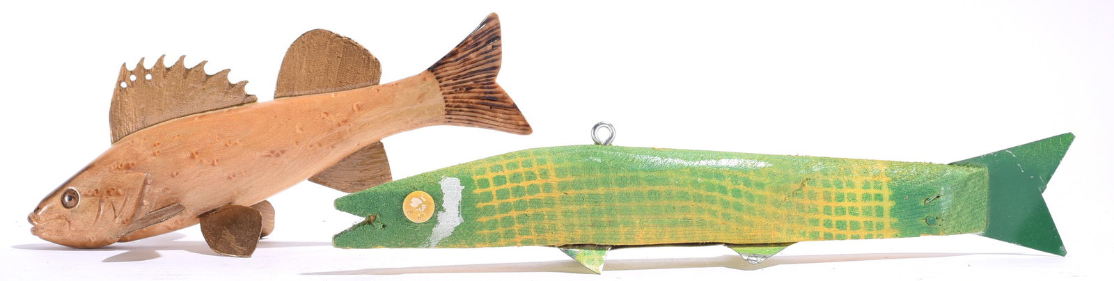 Matt Brown Carved Fish Decoys: Largest is 9"x1" Two carved wooden fish decoys by Matt Brown, including a natural-finish fish with carved fins and detailed tail together with a long green painted fish with geometric scale decoration