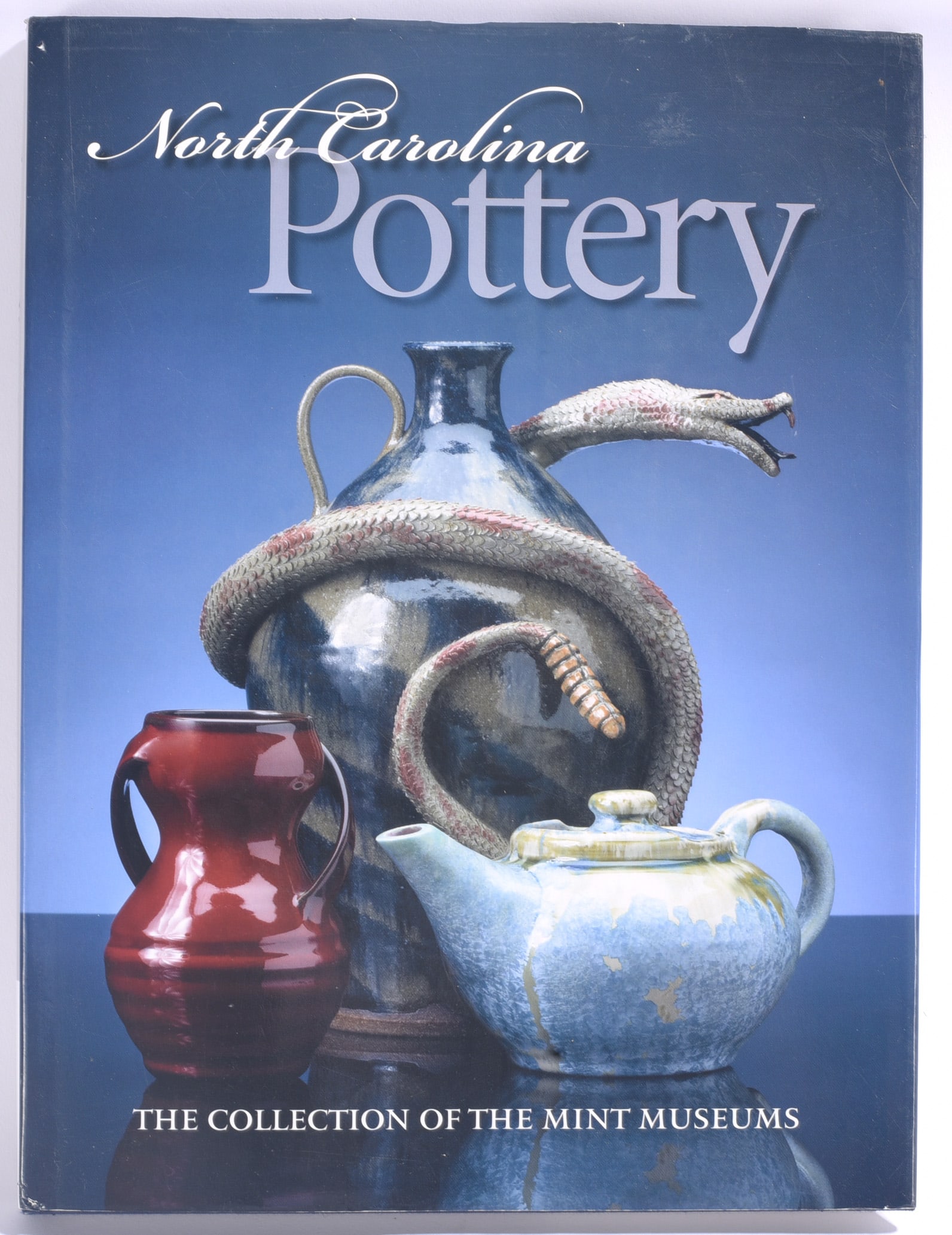 Mint Museum Collection North Carolina Pottery Reference Book: 10"x12" "North Carolina Pottery: The Collection of the Mint Museums." Illustrated reference book featuring examples from the Mint Museums collection and documenting the history and diversity of North