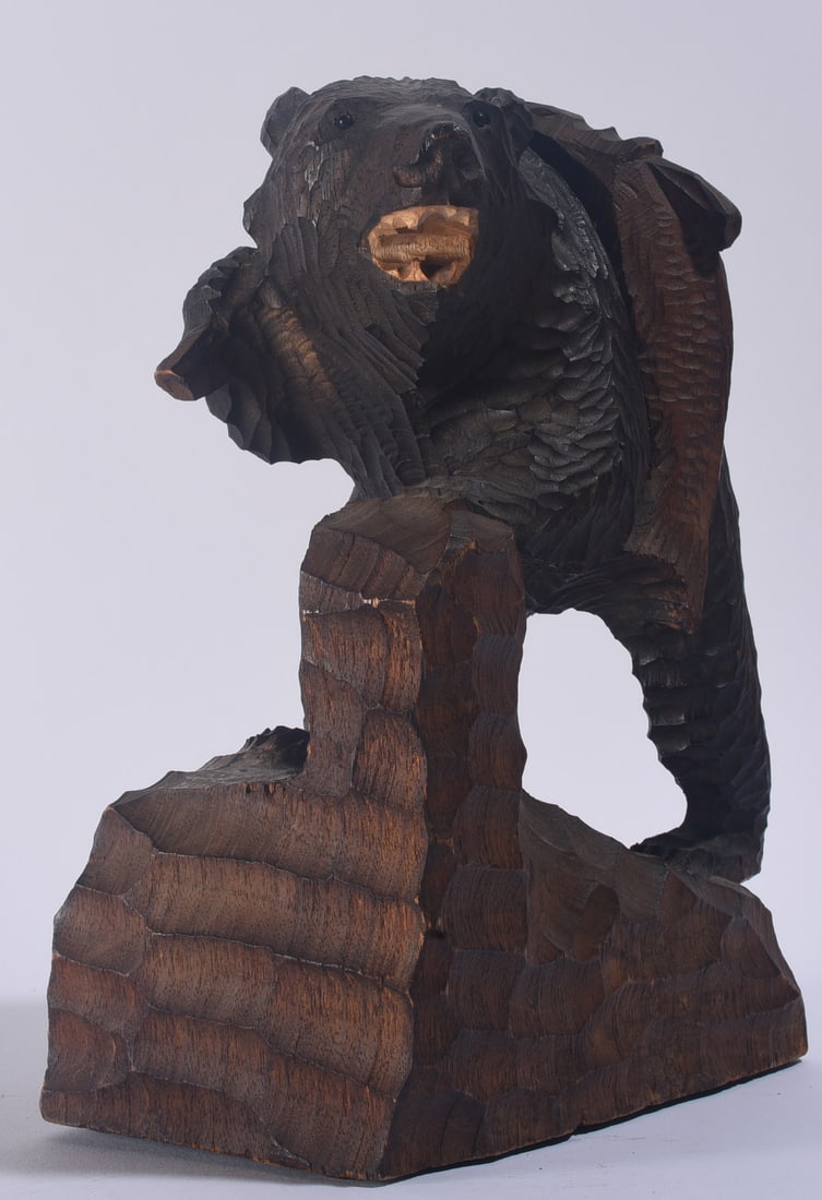 Carved Wooden Black Bear: 8"x12" Carved wooden black bear sculpture depicted standing against a rocky formation, with deeply carved fur detailing and natural wood accents.
