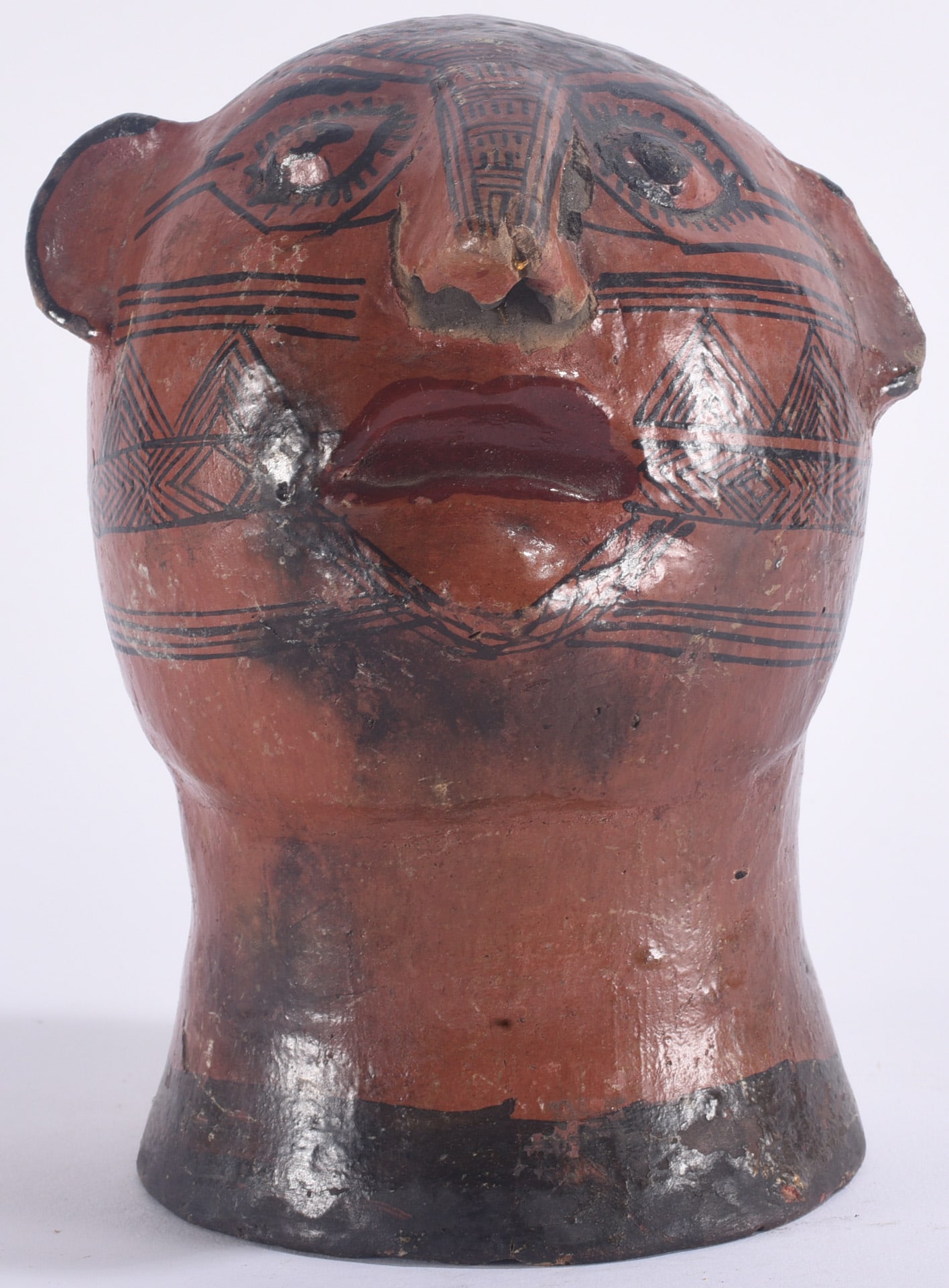 Native American Pottery Face Vessel: 6" Native American pottery face vessel with modeled facial features, painted and incised geometric decoration, and reddish-brown surface.