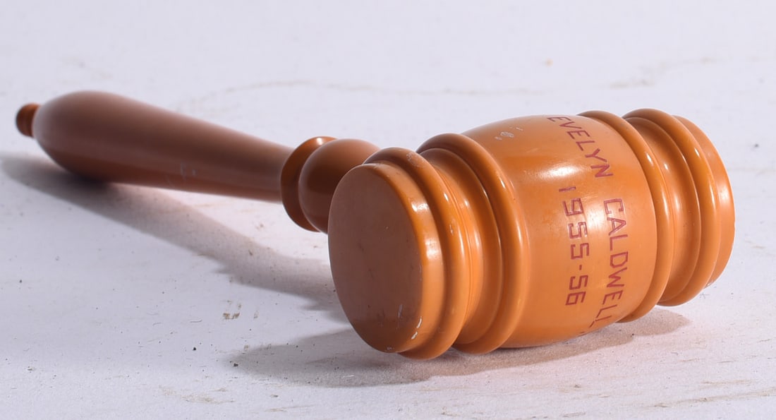Bakelite Ceremonial Gavel ca. 1955: 8" Vintage Bakelite ceremonial presentation gavel dated 1955–56, constructed in a warm butterscotch-colored material with turned handle and deeply molded head. Inscribed “EVELYN CALDWELL