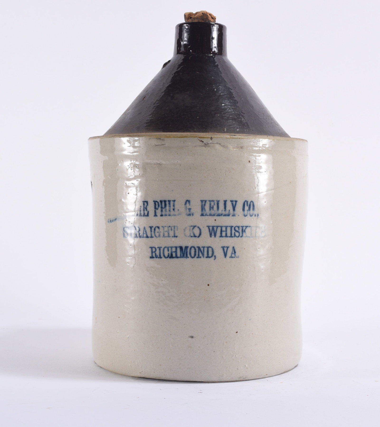 Phil G. Kelly Co. Richmond VA Stoneware Whiskey Jug: 12" Antique stoneware whiskey jug advertising "The Phil. G. Kelly Co., Straight (X) Whiskey, Richmond, VA." Cylindrical stoneware body with contrasting dark glazed shoulder and neck, blue stenciled ad