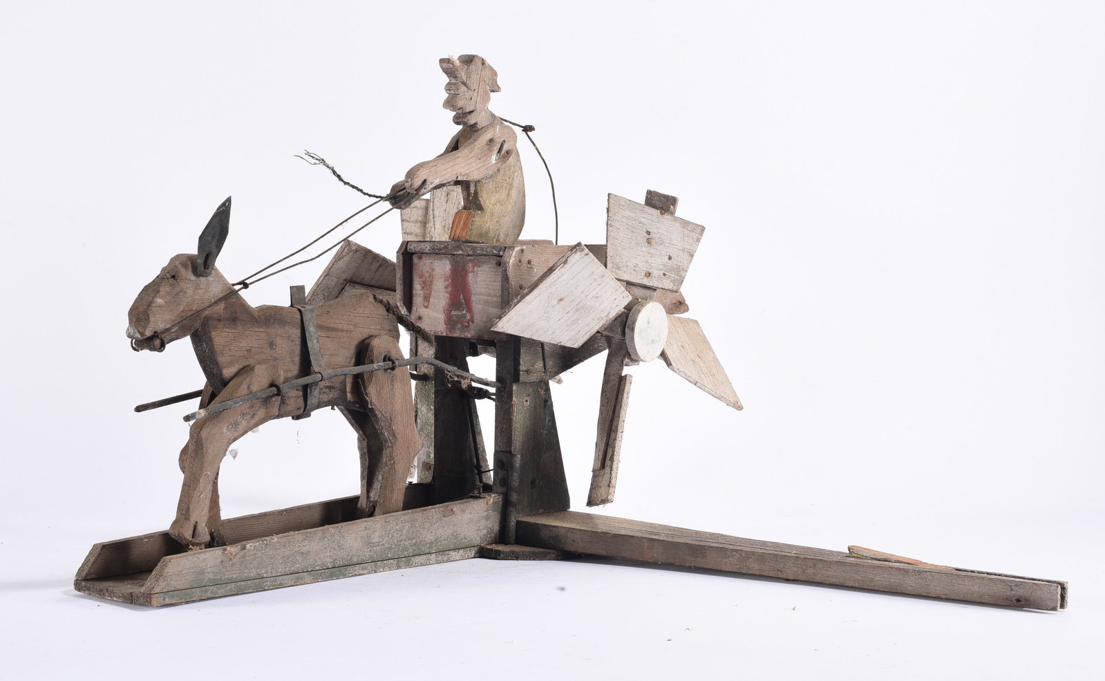 Antique Folk Art Horse and Rider Whirligig: 19"x23" x14" Large antique American folk art mechanical whirligig or action toy depicting a wooden horse and rider attached to a complex arrangement of wooden paddles, rods and wire linkages. Construc