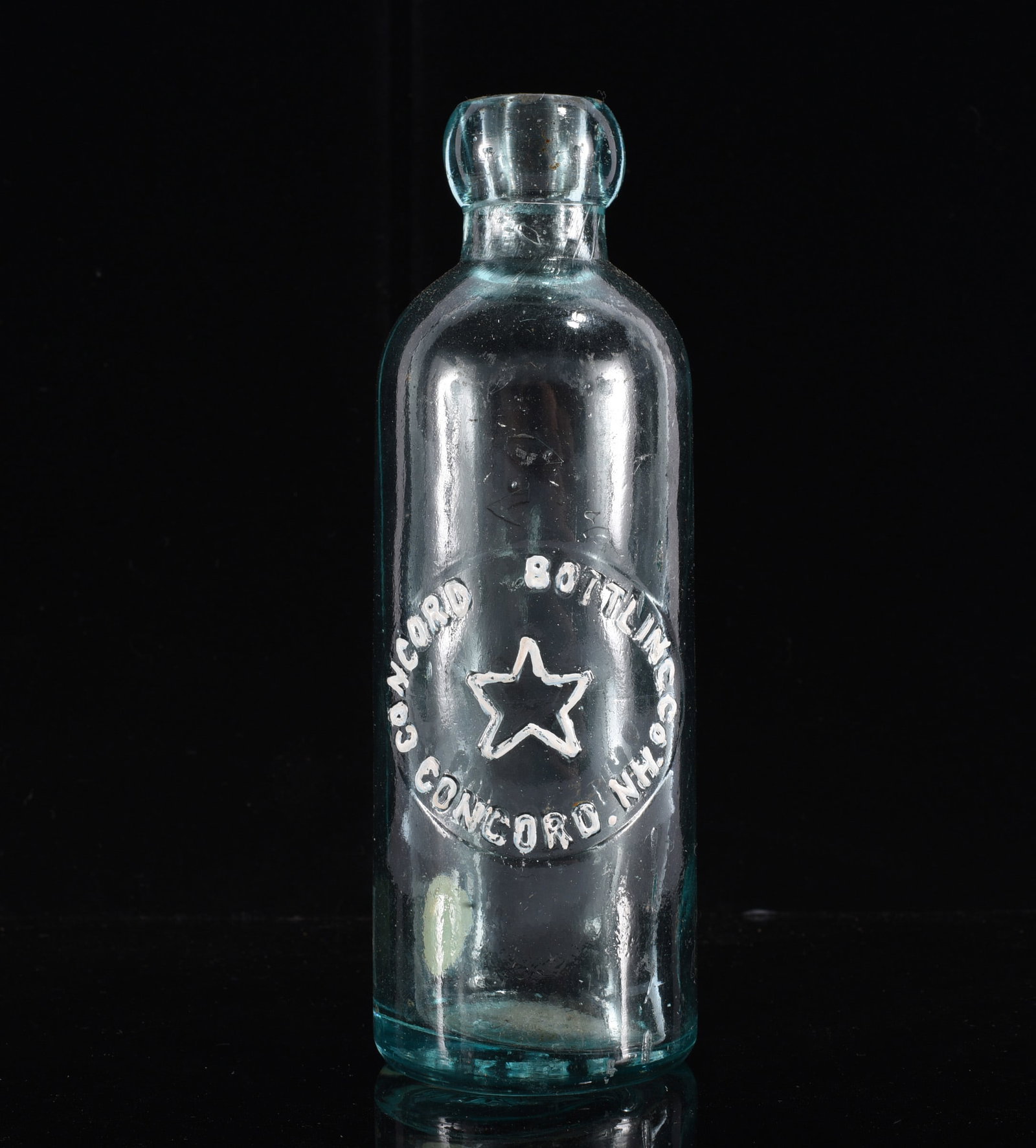 Concord Bottling Co. Concord NC Hutchinson Soda Bottle: 7" Antique aqua glass Hutchinson soda bottle embossed "Concord Bottling Co. / Concord, N.C." with central star emblem. Heavy early bottle form with blob top and attractive aqua coloration. A collectib