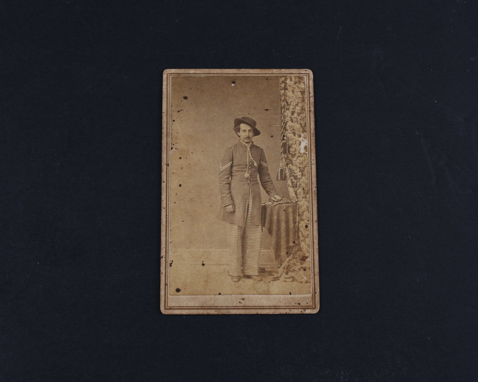 Confederate Soldier CDV - Atlanta Backmark: CDV of a Confederate soldier, full standing, in unusual pants. F. Kuhn’s, Atlanta, Georgia backmark. Slight paper loss on verso, near ID, else Very good condition.