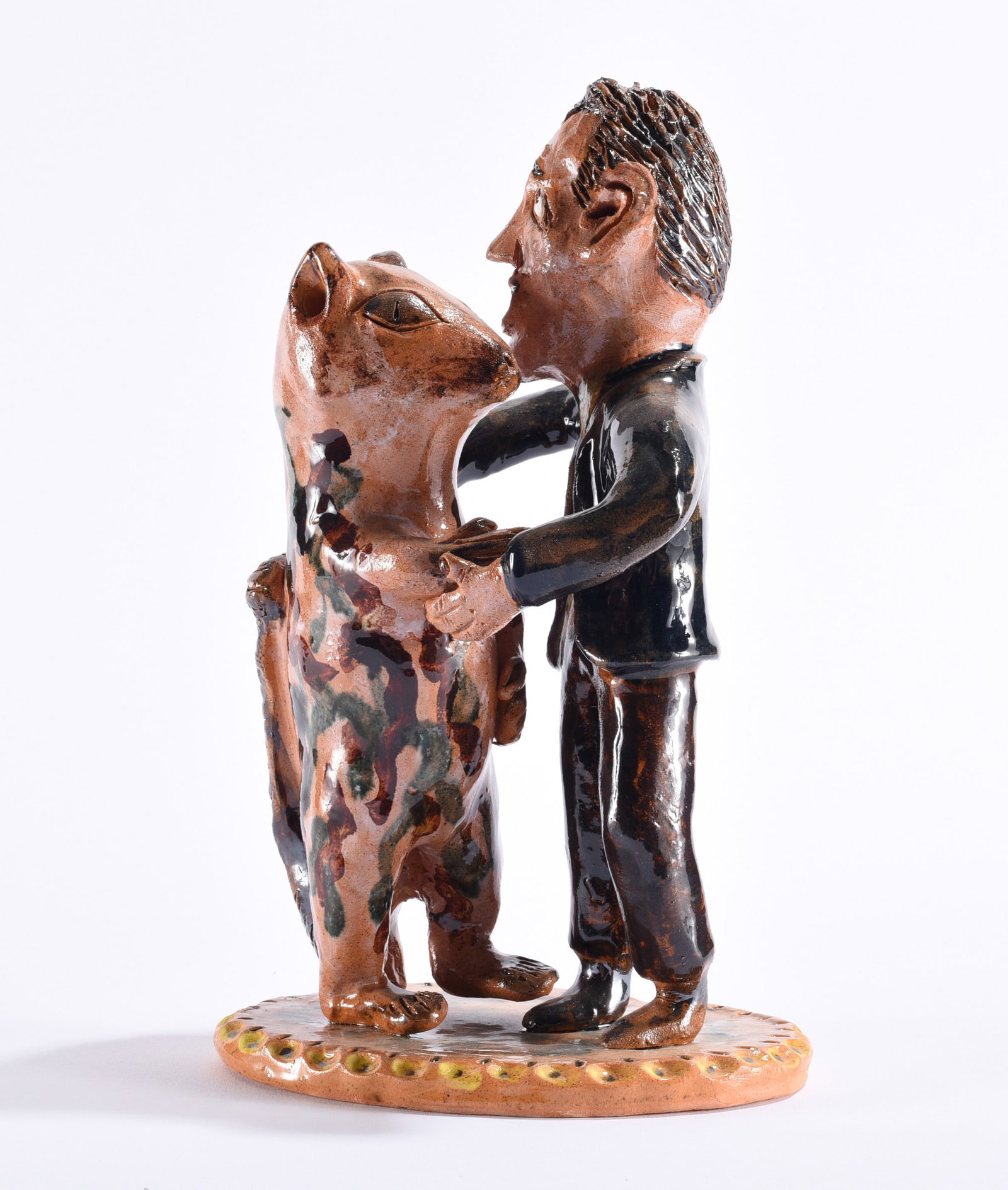Billy Ray Hussey Pottery Squirl Dancer: Billy Ray Hussey (b. 1955, Robbins, North Carolina) whimsical Southern folk pottery figural sculpture depicting a formally dressed man dancing or embracing an anthropomorphic squirrel, modeled in the 