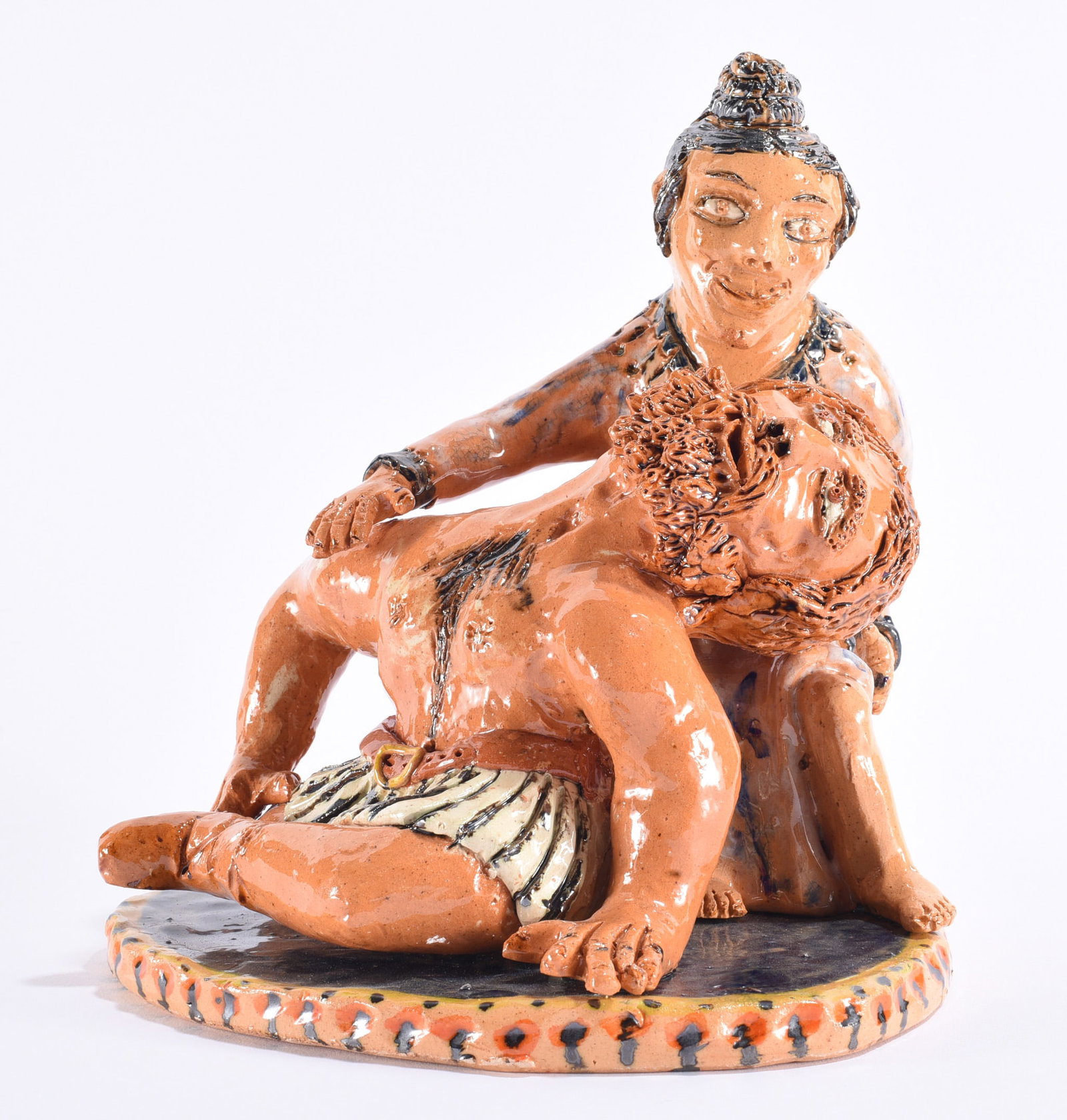 Billy Ray Hussey Samson and Delilah Pottery Figural: Billy Ray Hussey (b. 1955, Robbins, North Carolina) elaborate glazed pottery figural depicting the biblical story of Samson and Delilah, with Delilah supporting the reclining figure of Samson in a dra