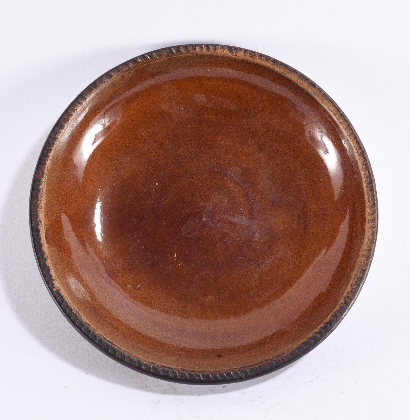 PA Pie Plate ca. 1870: Pennsylvania redware pie plate, circa 1870, wheel-thrown with shallow rounded well and slightly raised rim, covered in a rich reddish-brown glaze with darker accenting around the perimeter. Concentric