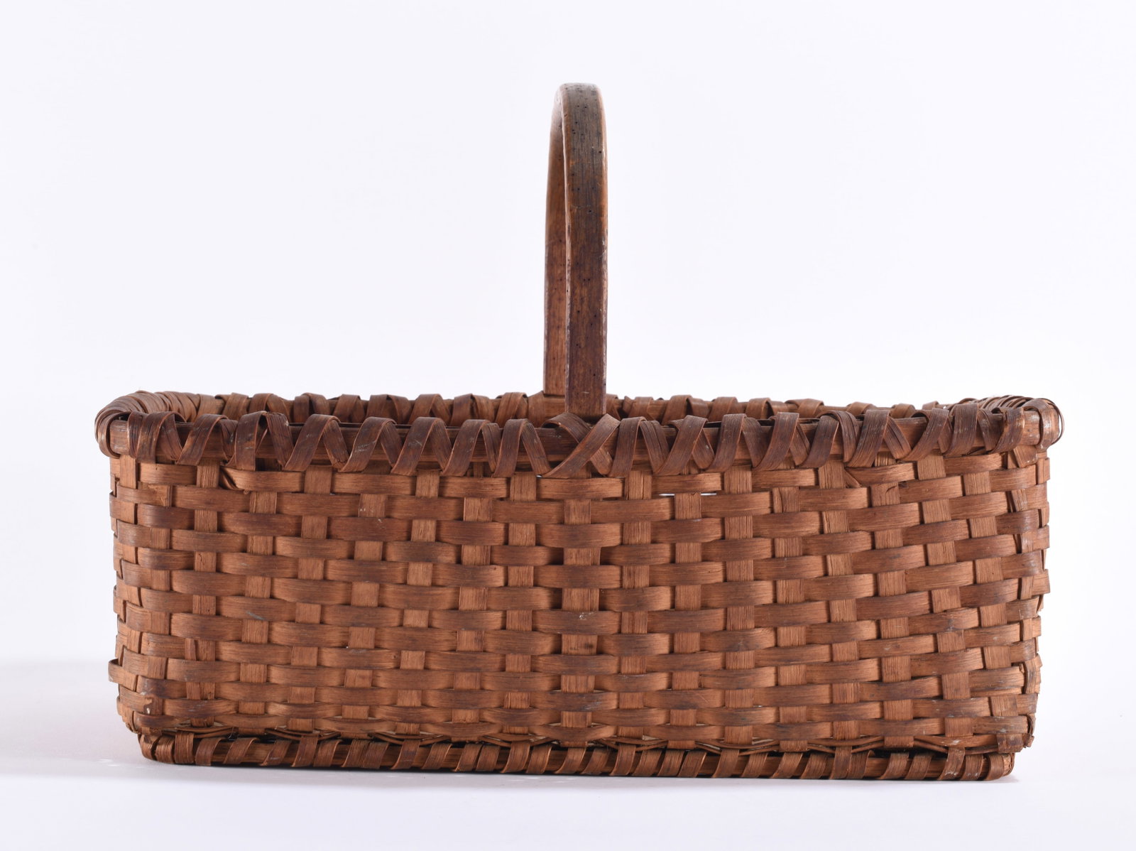 Antique Oak Split Appalachian Basket: Antique Appalachian oak-split gathering basket, hand woven in a rectangular form with a single tall wooden handle, woven bottom and decorative wrapped rim. Constructed from narrow hand-prepared oak sp
