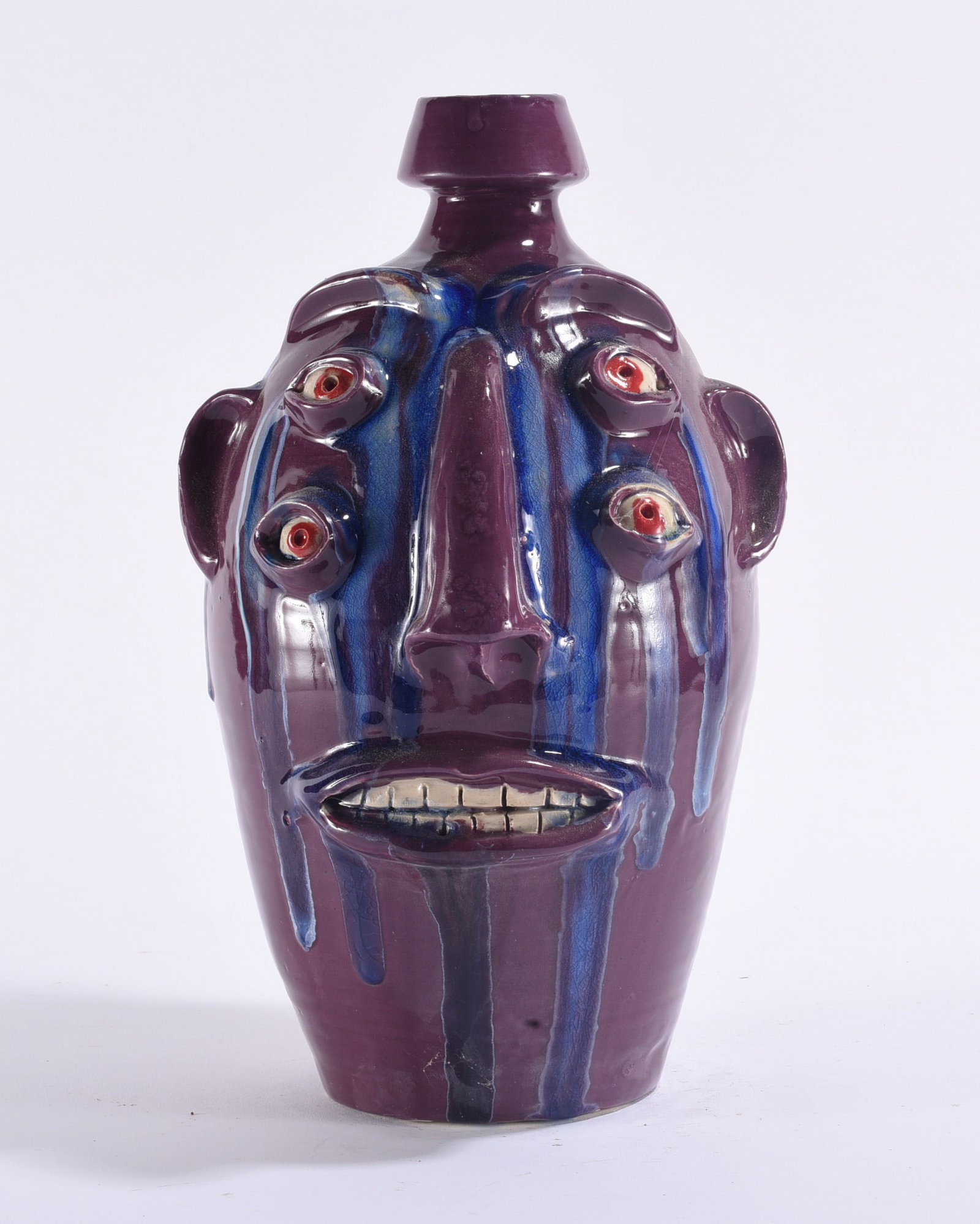 Randy Tobias Face Jug: Randy Tobias North Carolina folk pottery face jug, wheel-thrown with tall cylindrical body and applied facial features including ears, heavy brows, four individually modeled eyes, elongated nose and a