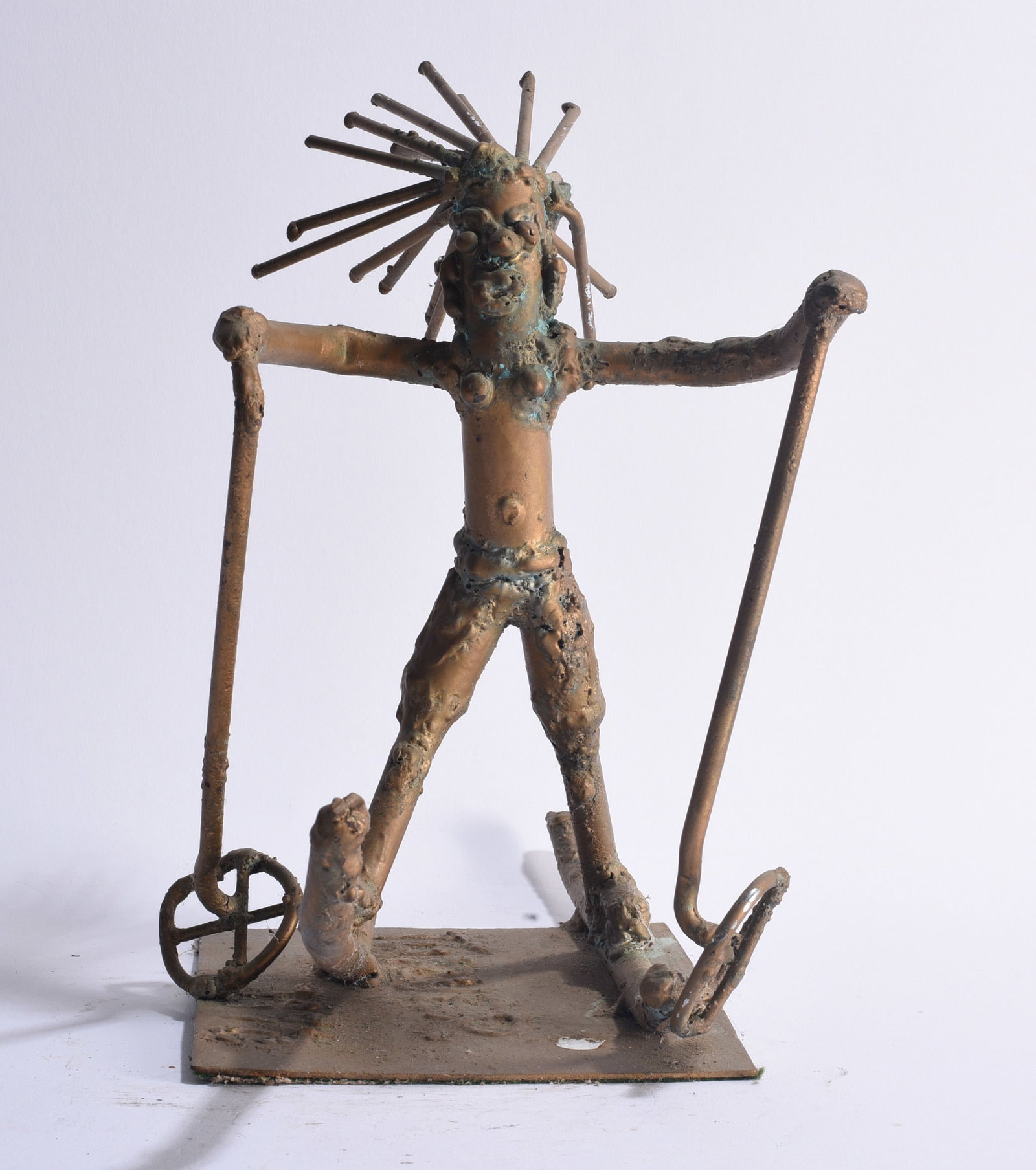 Willie Tarver (1932 - 2010) Sculpture: Figural found-metal sculpture by Willie Tarver (1932–2010), depicting an expressive standing figure with outstretched arms, radiating metal elements forming the hair and long implements held in each