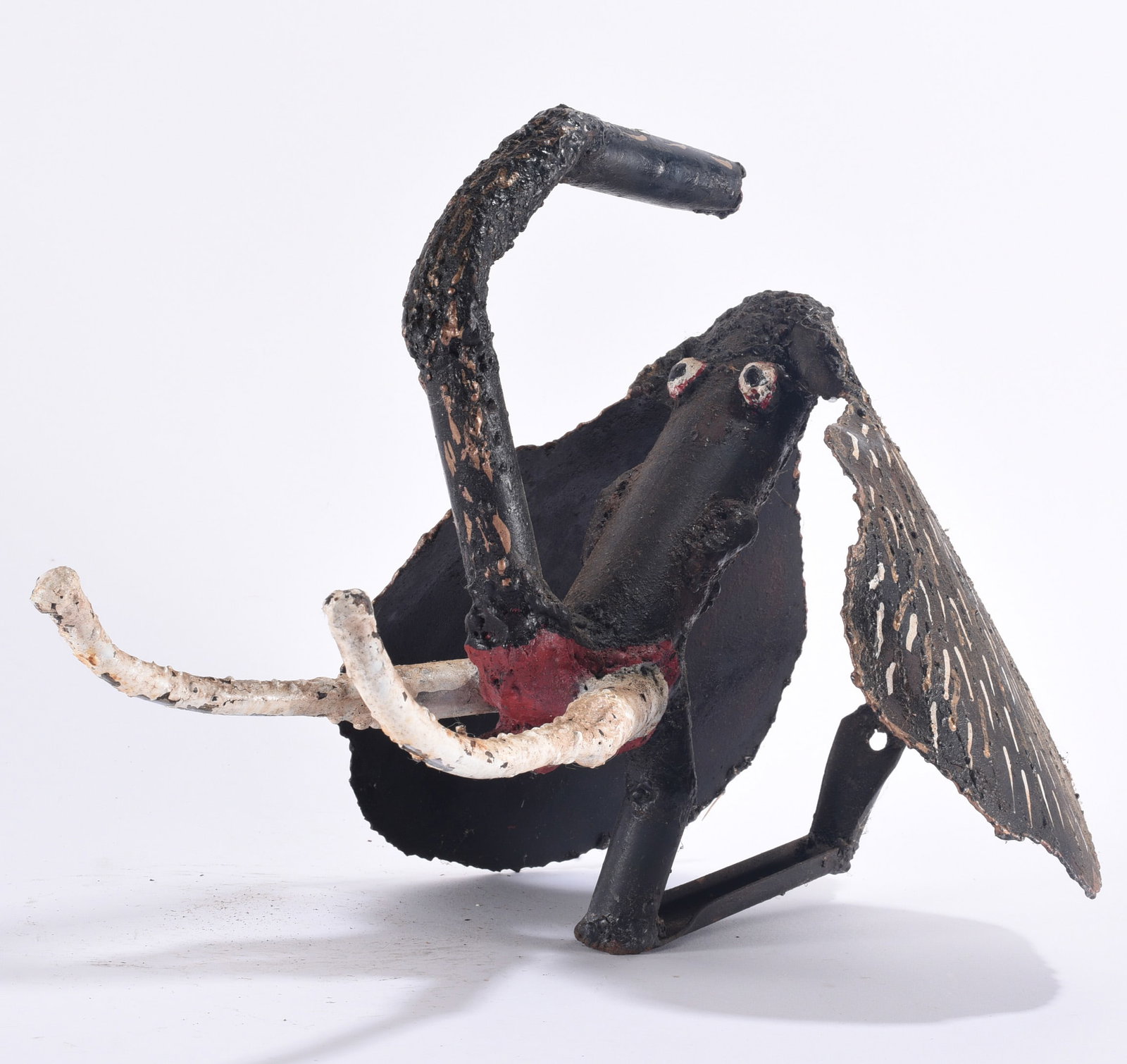 Willie Tarver (1932 - 2010) Sculpture: Whimsical found-metal sculpture by Willie Tarver (1932–2010), depicting a reclining or seated fantastical figure with exaggerated elongated features and dramatically extended limbs. Constructed from