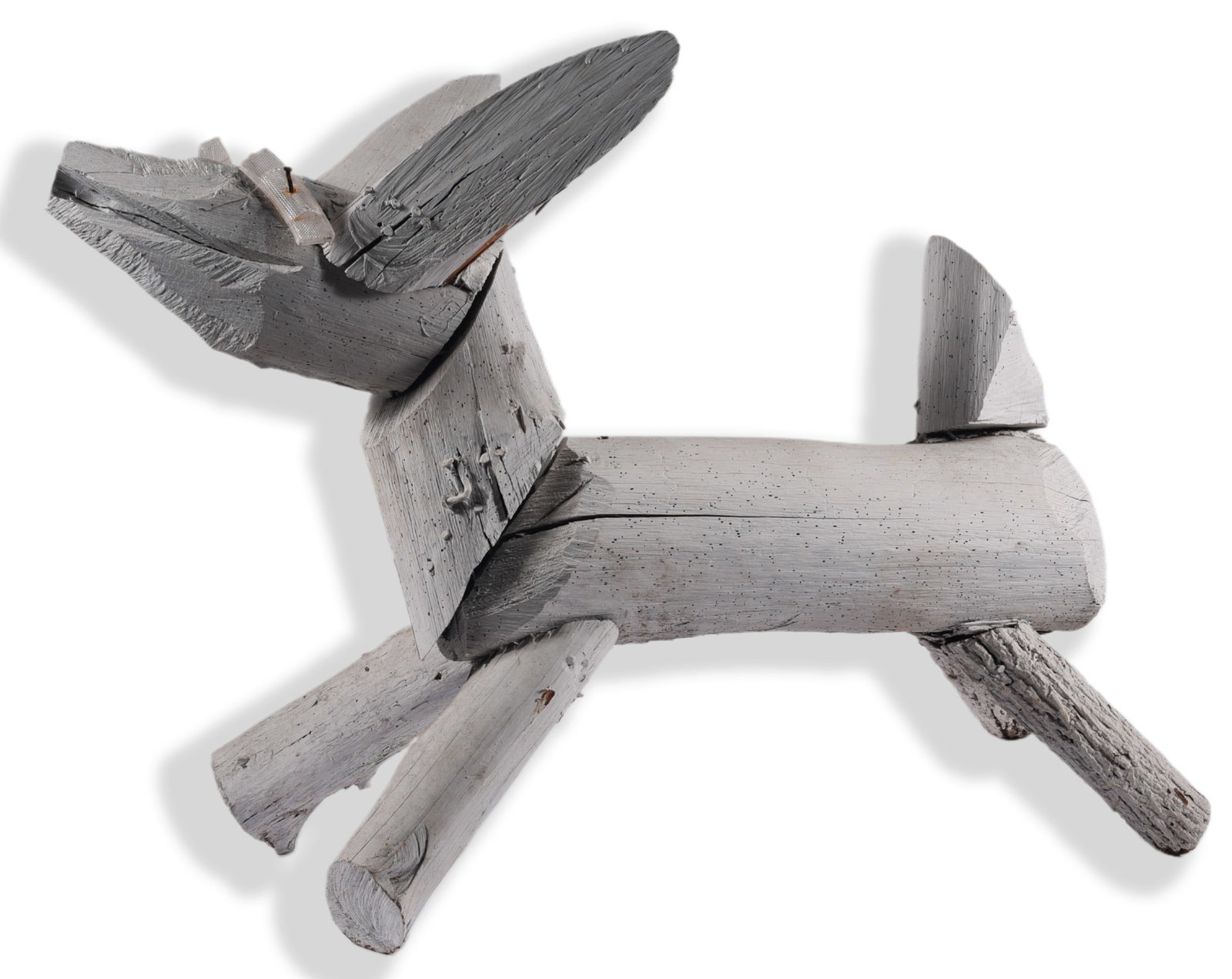 Clyde Jones Folk Art Dog Monumental Size: Monumental folk art dog sculpture by Clyde Jones constructed from roughly cut and assembled sections of salvaged wood. Painted primarily white and retaining visible nails, weathered surfaces and