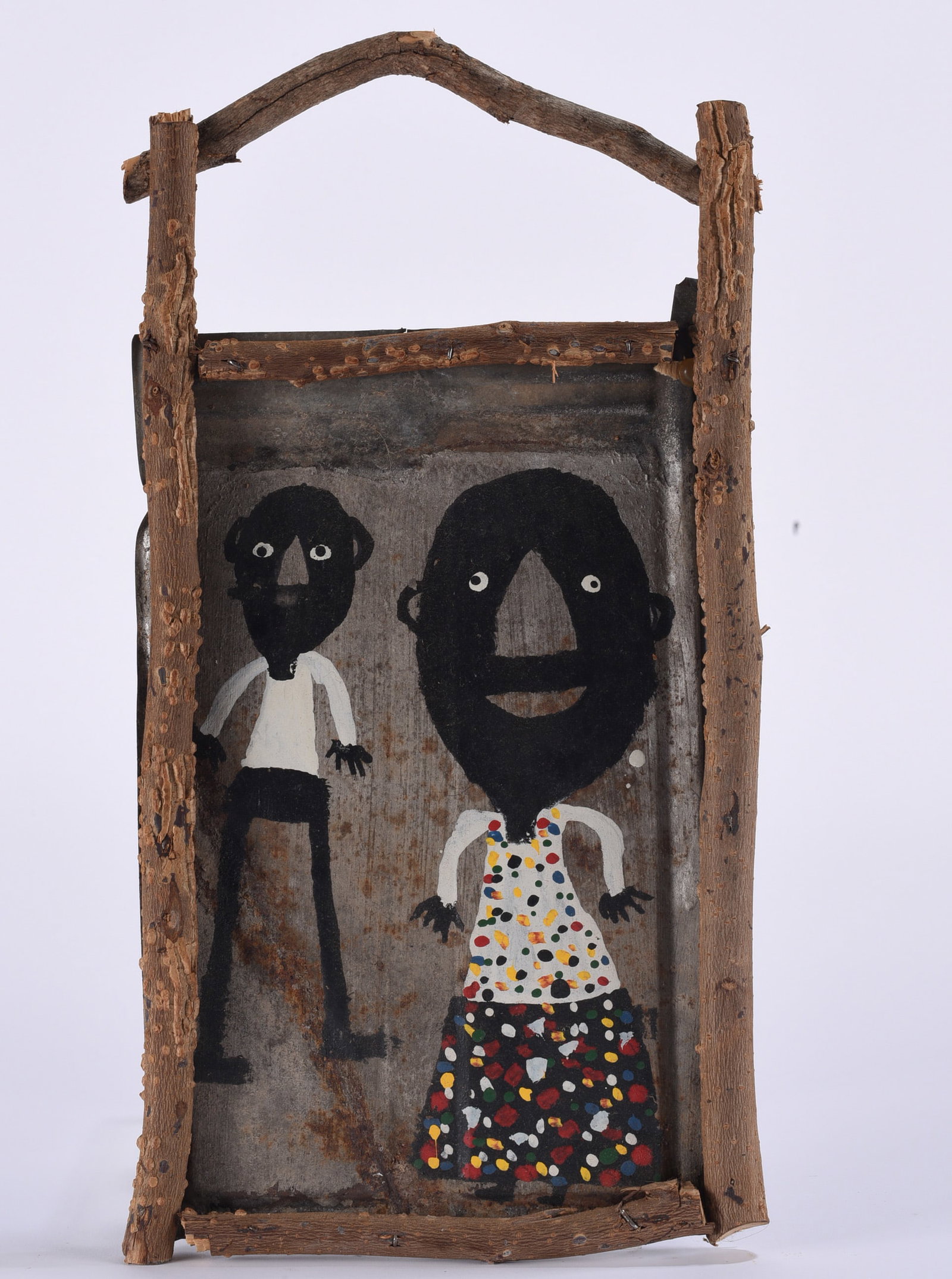 James Buddy Snipes Folk Art Painting: James “Buddy” Snipes folk art painting on found metal depicting two stylized figures, one wearing a brightly patterned dress, within a rustic branch-form frame and handle. A strong example of