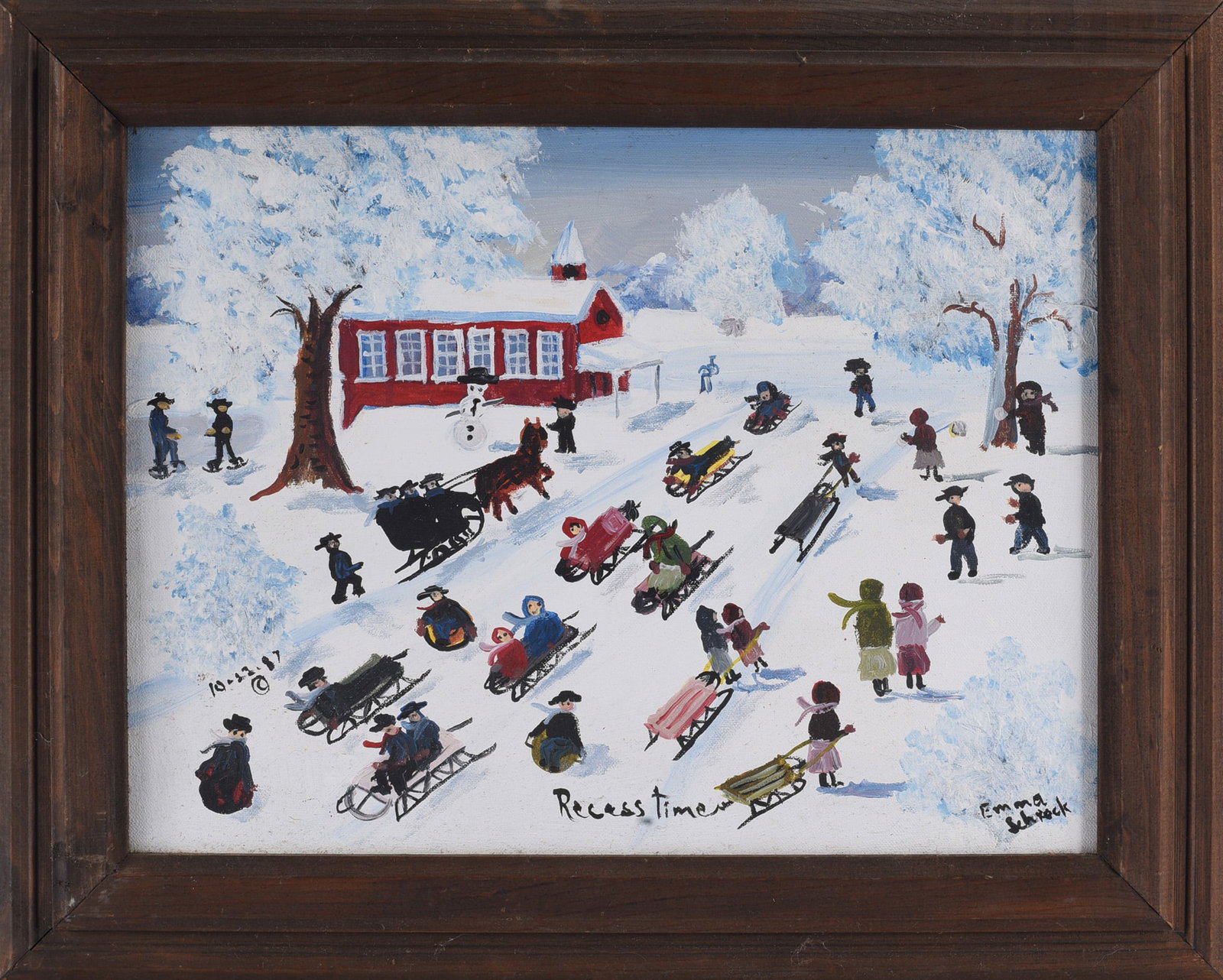 Emma Schrock Folk Art Painting: Emma Schrock (American, 1924–1991) folk art painting depicting a wintertime schoolyard scene with children sledding and playing in the snow before a red schoolhouse. Signed “Emma Schrock” lo