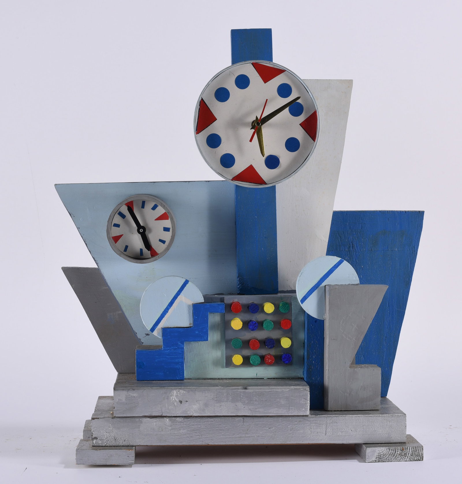 Contemporary Abstract Art Form: Contemporary abstract sculptural art form constructed from painted wood and found clock components, featuring intersecting geometric shapes, two clock faces and colorful circular accents. Executed