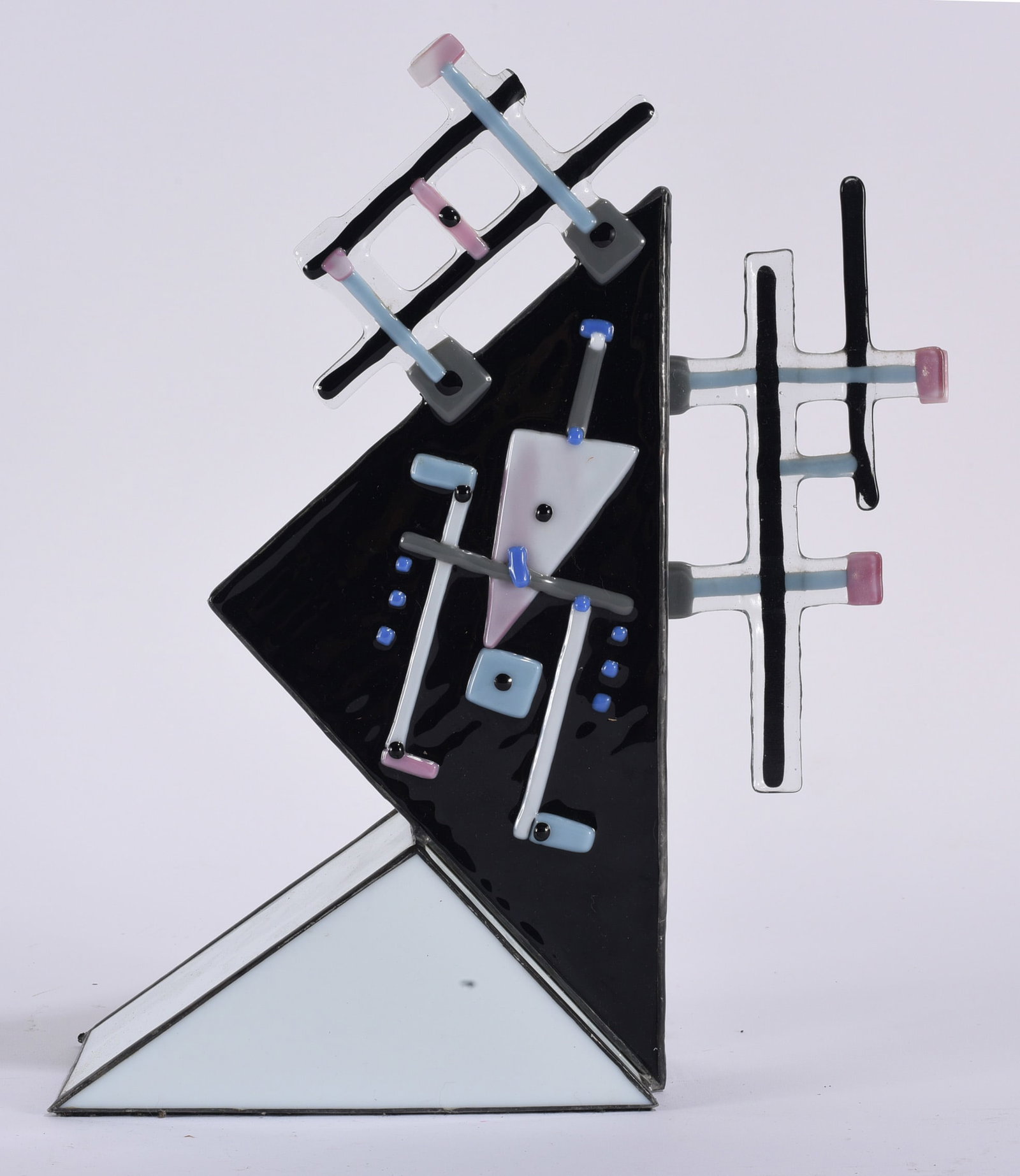 Memphis Style Abstract Geometric Glass Sculpture: Memphis-style abstract geometric glass sculpture composed of angular black and white planes accented with fused linear and geometric elements in pale blue, pink, gray, and black. The asymmetrical arch