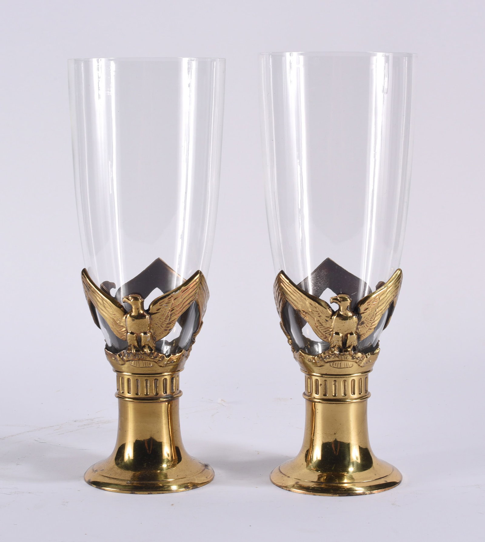 PM Craftsman Philadelphia Solid Brass Federal Candleholders: Pair of PM Craftsman, Philadelphia, Federal-style candleholders constructed in polished solid brass with clear glass hurricane shades. Each features an eagle motif with outstretched wings above a