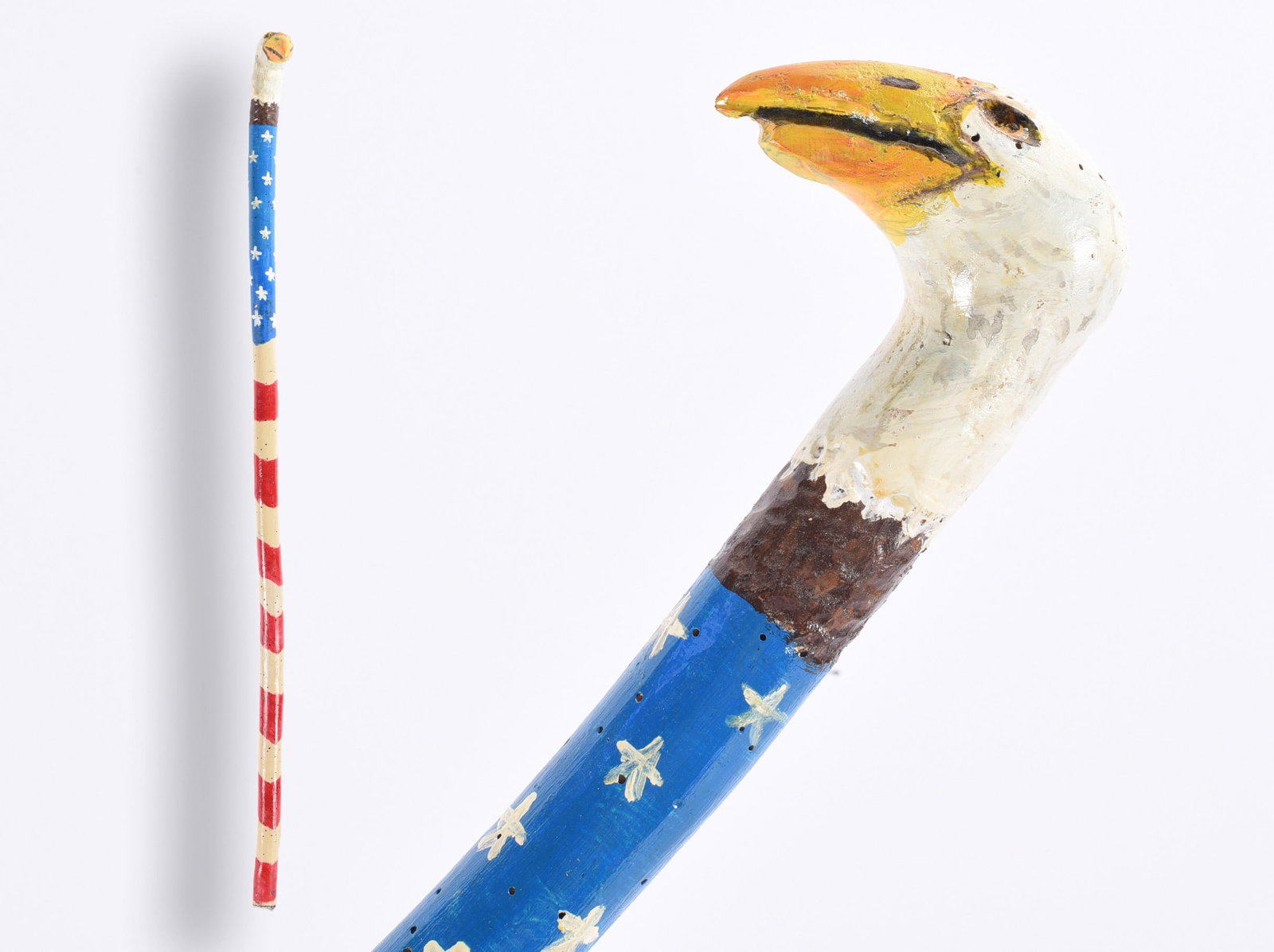 Richard Roebuck Folk Art Painted Cane Walking Stick: Hand-carved and painted folk art walking stick by Richard Roebuck, featuring a boldly carved eagle head with white plumage and yellow-orange beak. The shaft is painted blue with white star-like decora