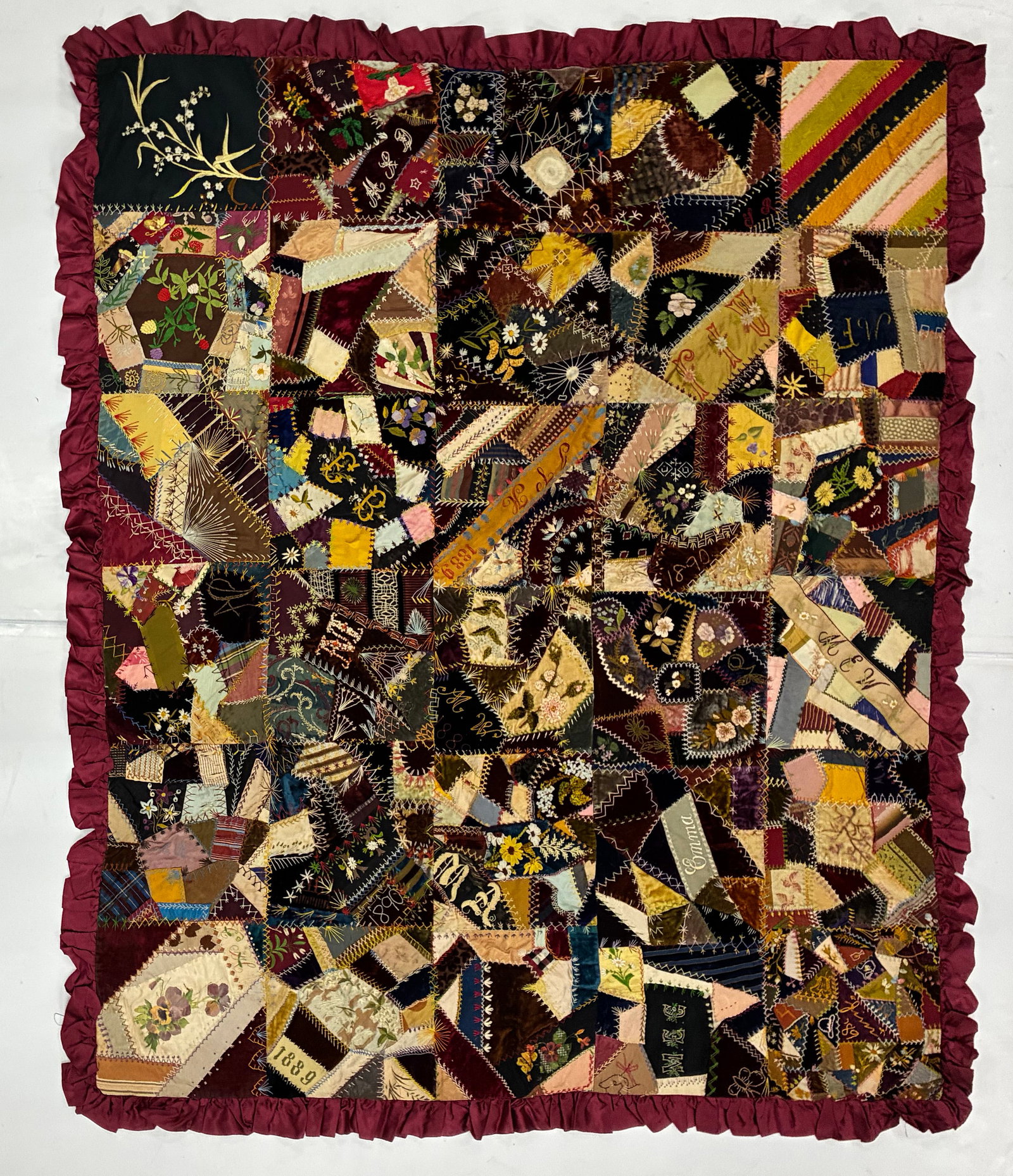 Victorian American Embroidered Crazy Quilt, Dated 1889: 72"x60" Elaborately worked American Crazy Quilt composed of silk, velvet, satin and other fine fabric remnants joined with an extraordinary variety of decorative embroidery stitches. Numerous patches 