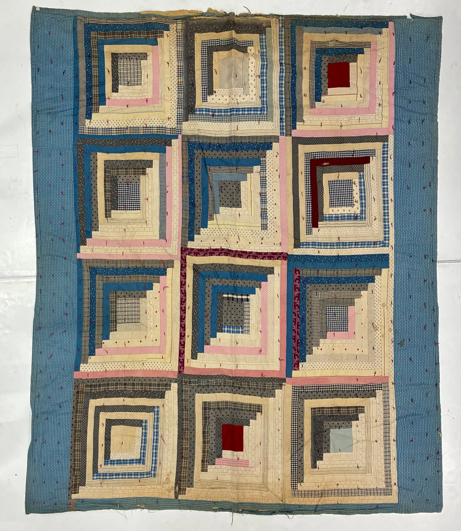 Early 20th Century American Log Cabin Tied Scrap Quilt: 80"x74" Early 20th century American Log Cabin quilt composed of twelve large strip-pieced blocks constructed from cream, blue, pink, gray, black, plaid, checked and small-scale printed fabrics. Each b