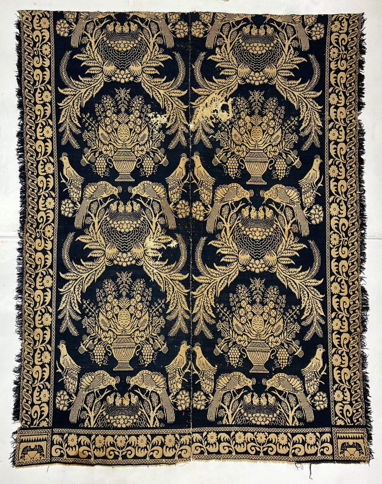 American Figured Jacquard Woven Coverlet with Birds & Floral Urns: 86"x76" American figured jacquard woven coverlet or decorative textile worked in a dramatic dark navy or black and golden tan palette. The elaborate repeating design features large floral urns, styliz