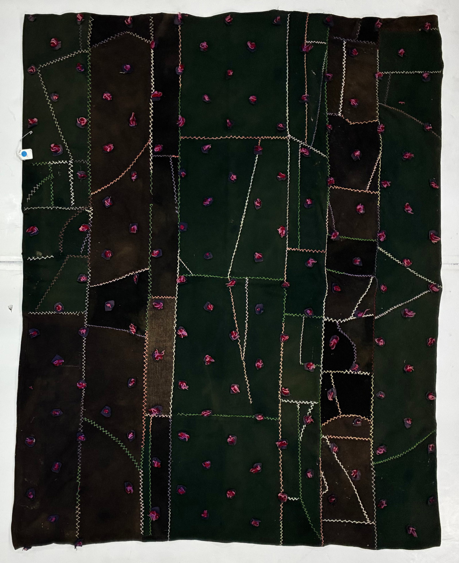 Early 20th Century American Crazy Quilt in Dark Wool with Tufted Accents: 68"x58" Early 20th century American Crazy Quilt or improvisational wool textile assembled from irregular dark green, brown and black fabric pieces joined with contrasting decorative embroidery