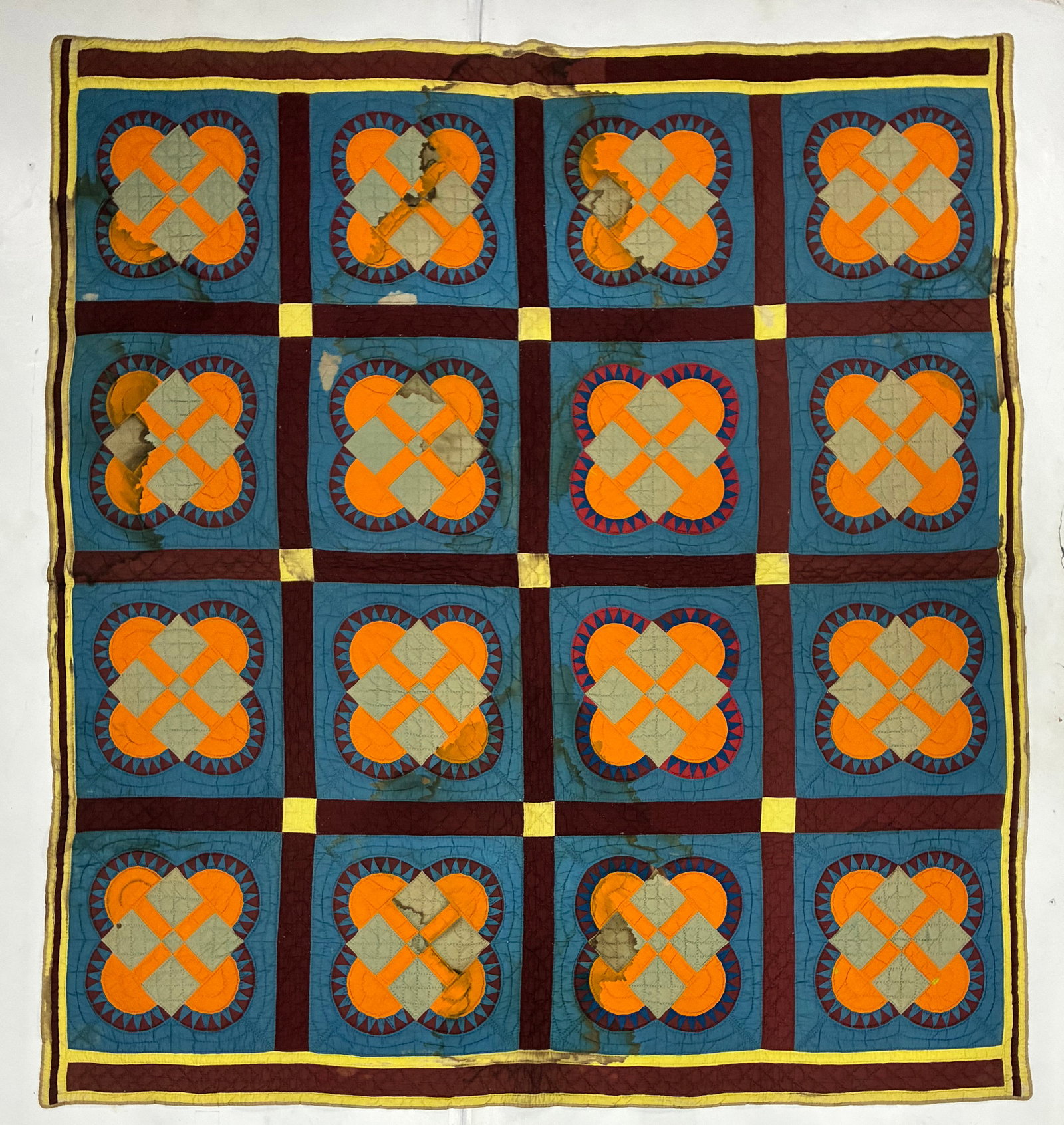 Signed ECB Interlocking Ring Appliqué Quilt ca. 1920: 78"x82" American appliqué quilt composed of sixteen large blocks featuring interlocking curved orange forms surrounding pale gray diamond centers on a deep blue ground. Each block is further accented