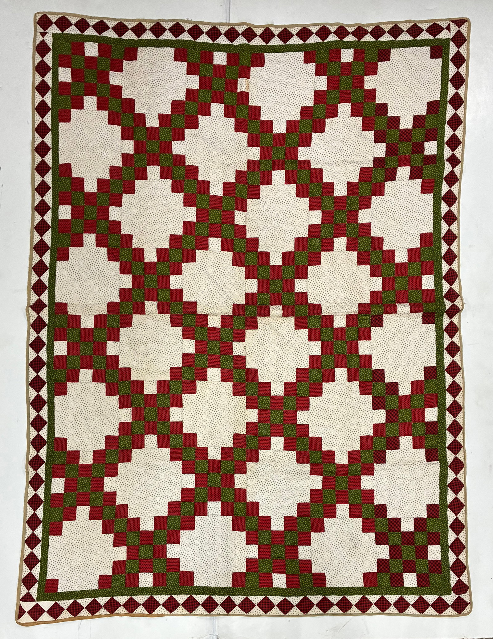 American Double Irish Chain Quilt in Red, Green & White: 69"x89" American Double Irish Chain quilt worked in a strong red, green and white palette. Small red and green squares form continuous interlocking diagonal chains surrounding large open cream areas,