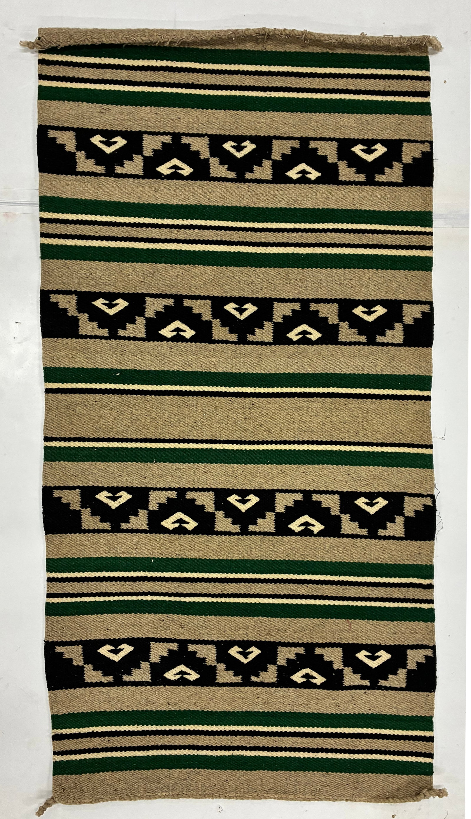 Vintage Handwoven Green Black and Cream Geometric Textile: 59"x30" Handwoven textile featuring alternating green, black, cream and tan horizontal bands with repeated geometric motifs arranged within black registers. The restrained palette and rhythmic