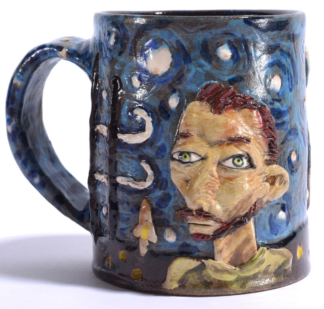 Stacy Lambert Van Gogh Mug: 4.5" North Carolina folk pottery mug by Stacy Lambert, hand-built and richly decorated with a dimensional portrait of Vincent van Gogh against a swirling blue night sky recalling The Starry Night.