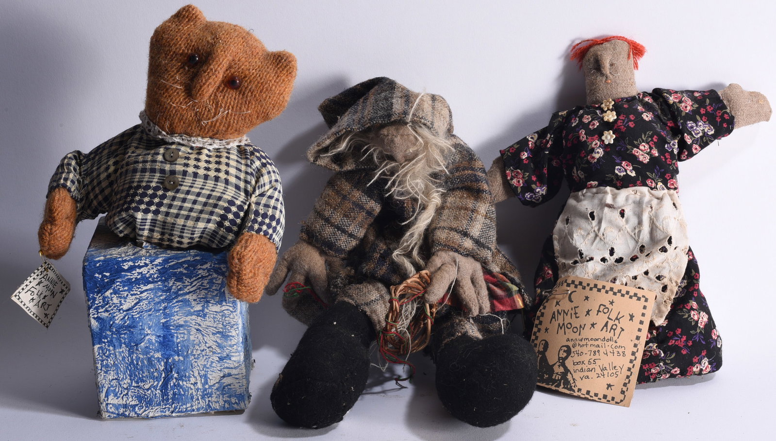 Folk Art Dolls by Annie Moon: Largest 16" Group of three handmade folk art dolls associated with Annie Moon, constructed from fabric, wool and found textiles and dressed in individually fashioned clothing. The group includes a cat