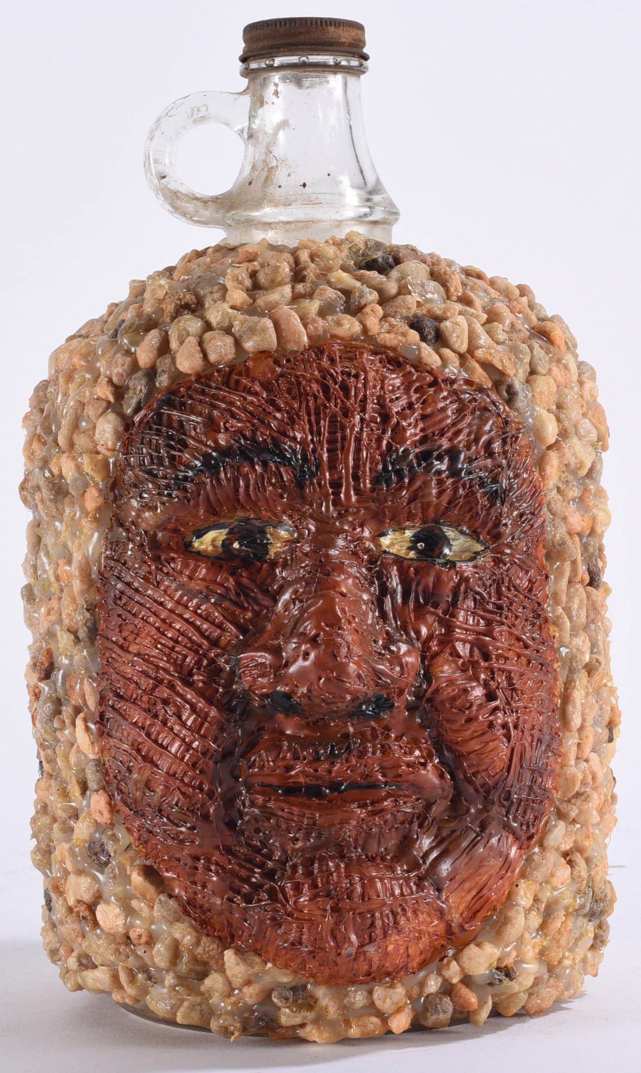 Richard Roebuck Folk Art Face Jug Bottle: 13" Richard Roebuck (born 1960) is a Southern folk artist known for paintings depicting African American life, Southern history, animals and imaginative subjects. Roebuck began drawing and painting