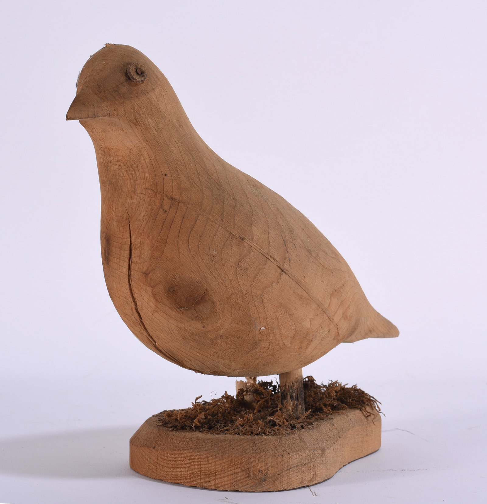 Folk Art Carved Wooden Bird Sculpture: 8"x8" Primitive folk art bird sculpture hand carved from a solid piece of wood and mounted on a simple wooden base. The bird is rendered with an economical, pleasing silhouette, incised wing detail an