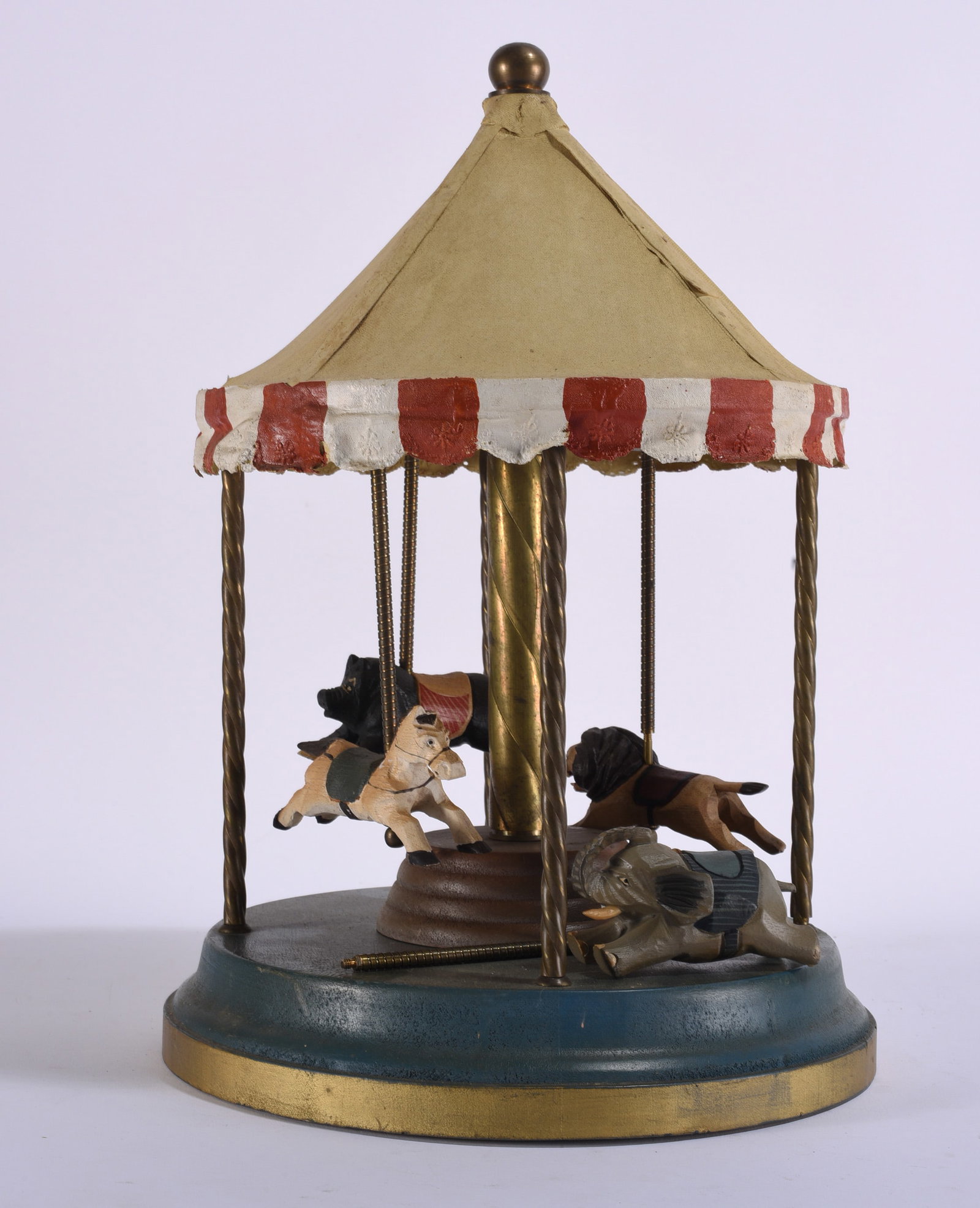 Vintage Folk Art Carousel with Carved Animals: 10"x17" Vintage folk art carousel or merry-go-round featuring a tent-form fabric canopy supported by metal posts above a circular painted base. Fitted with a group of carved and painted animal figures