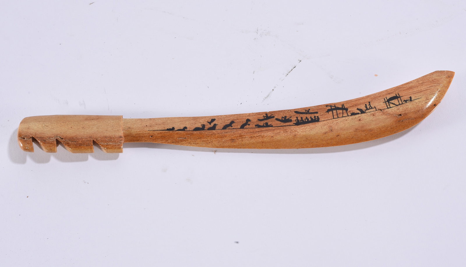 Carved Wooden Folk Art Machete or Ceremonial Knife: 12" Hand-carved wooden machete or ceremonial knife with elongated curved blade and notched handle. One side of the blade is decorated with a line of small black pictorial symbols depicting figures, an