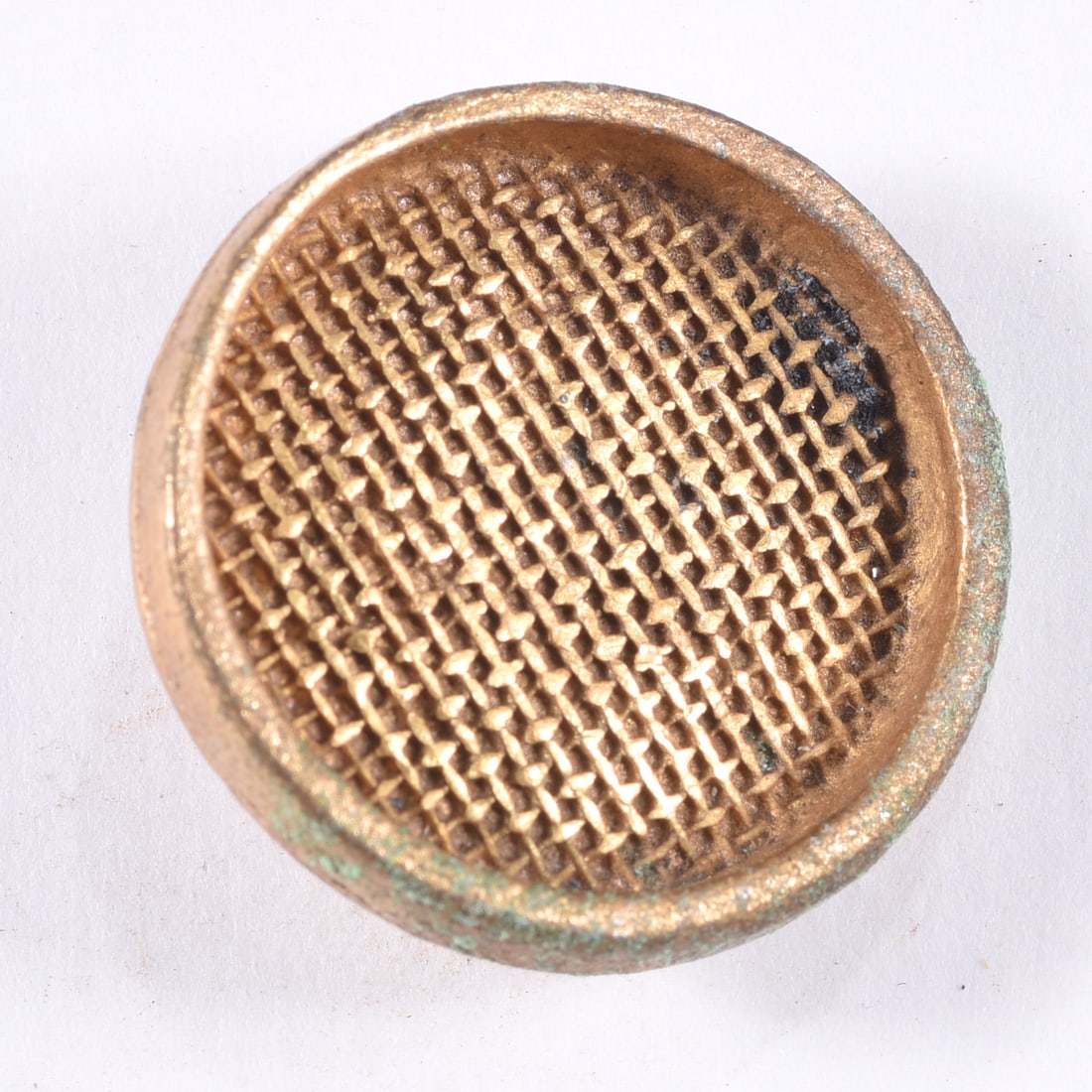Antique Gilt Metal Woven Pattern Button: Antique round gilt metal button with a deeply textured woven or basket-weave face enclosed by a raised rim. Reverse retains an integral metal loop shank. Surface shows oxidation, verdigris and age-rel